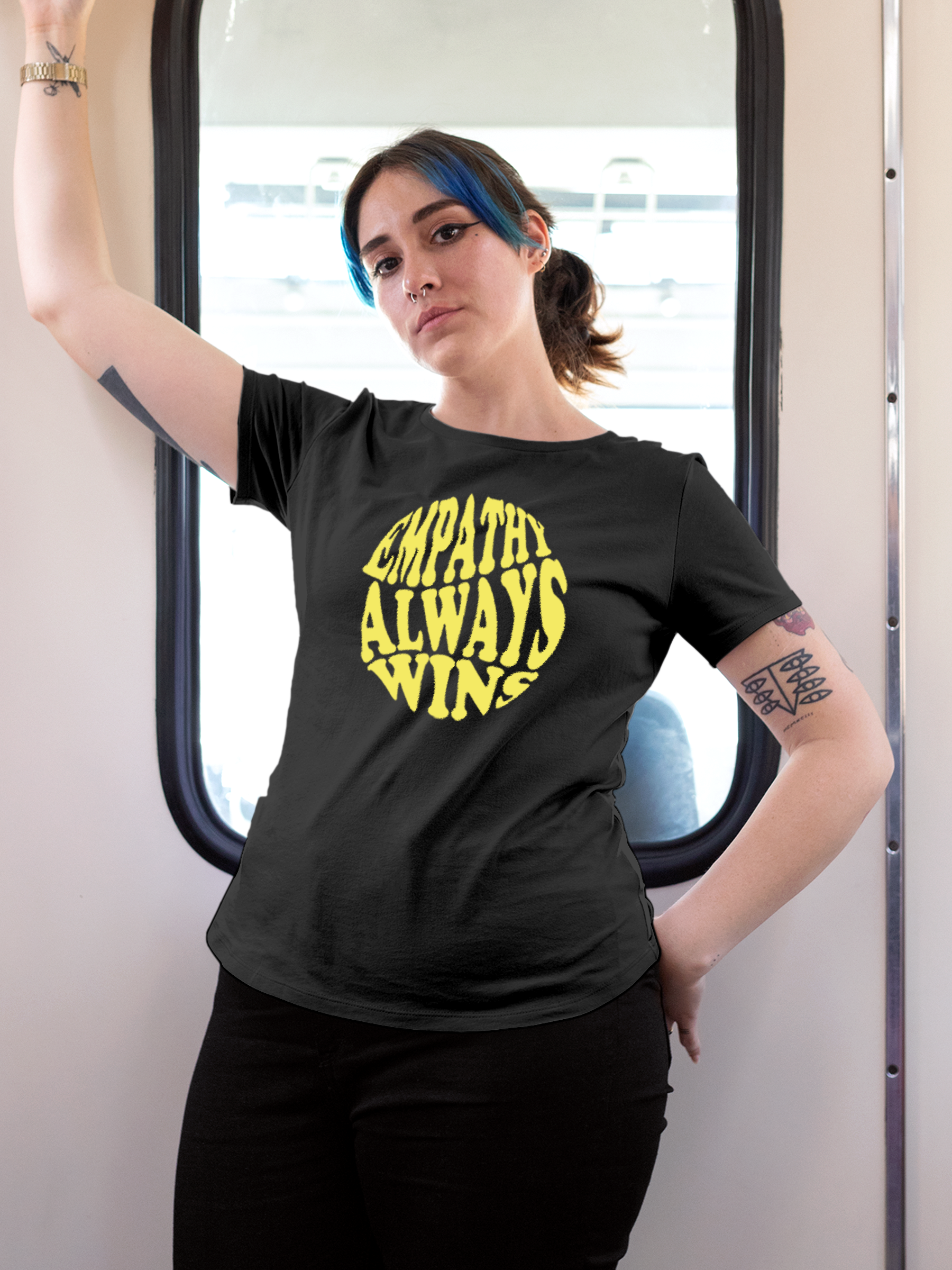 Model wearing Women's Dark Grey Round Neck T-shirt with 'Empathy Always Wins' design, offering effortless style and premium comfort