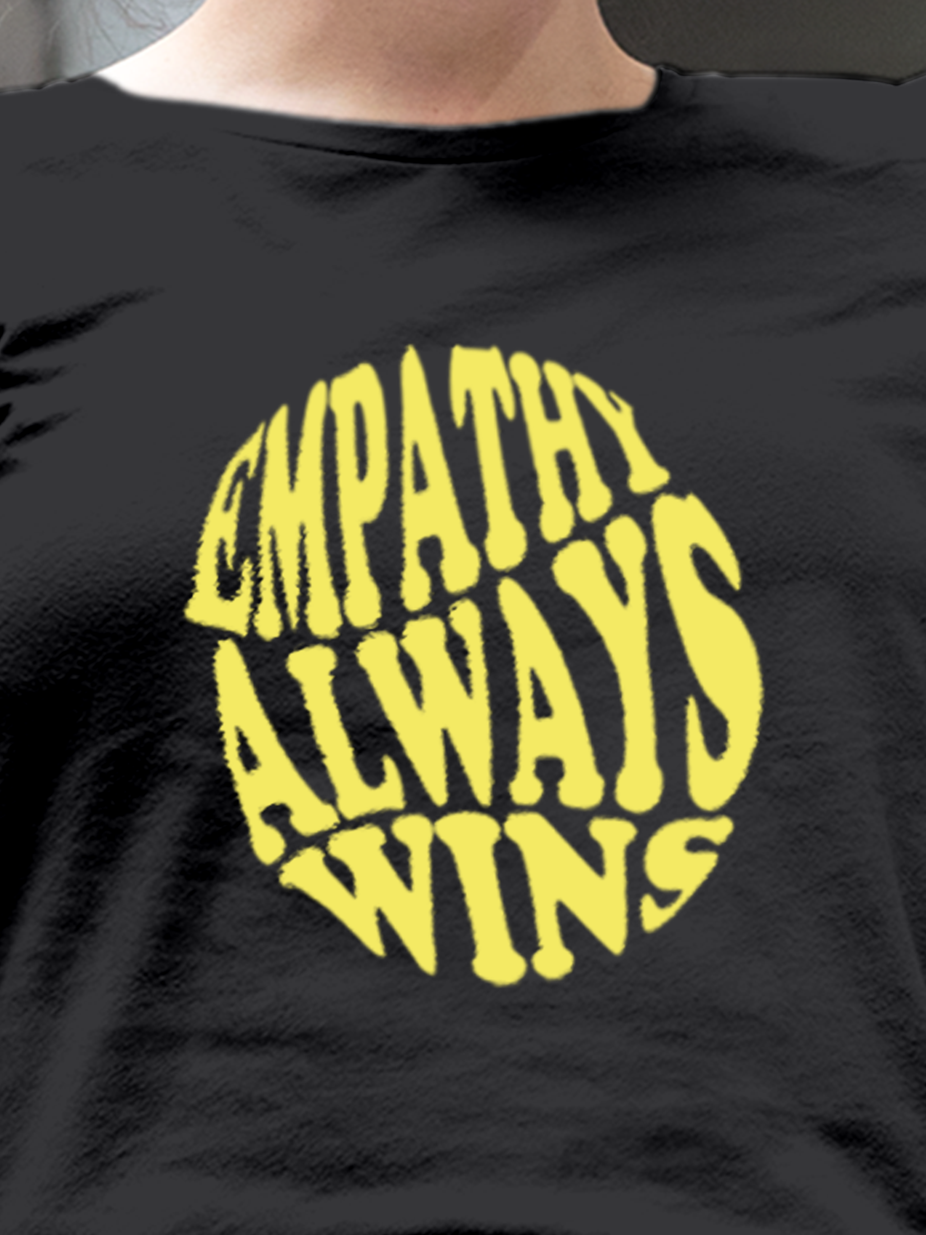 Close up of 'Empathy Always Wins' design on Women's Dark Grey Round Neck T-shirt, highlighting intricate details and vibrant print.