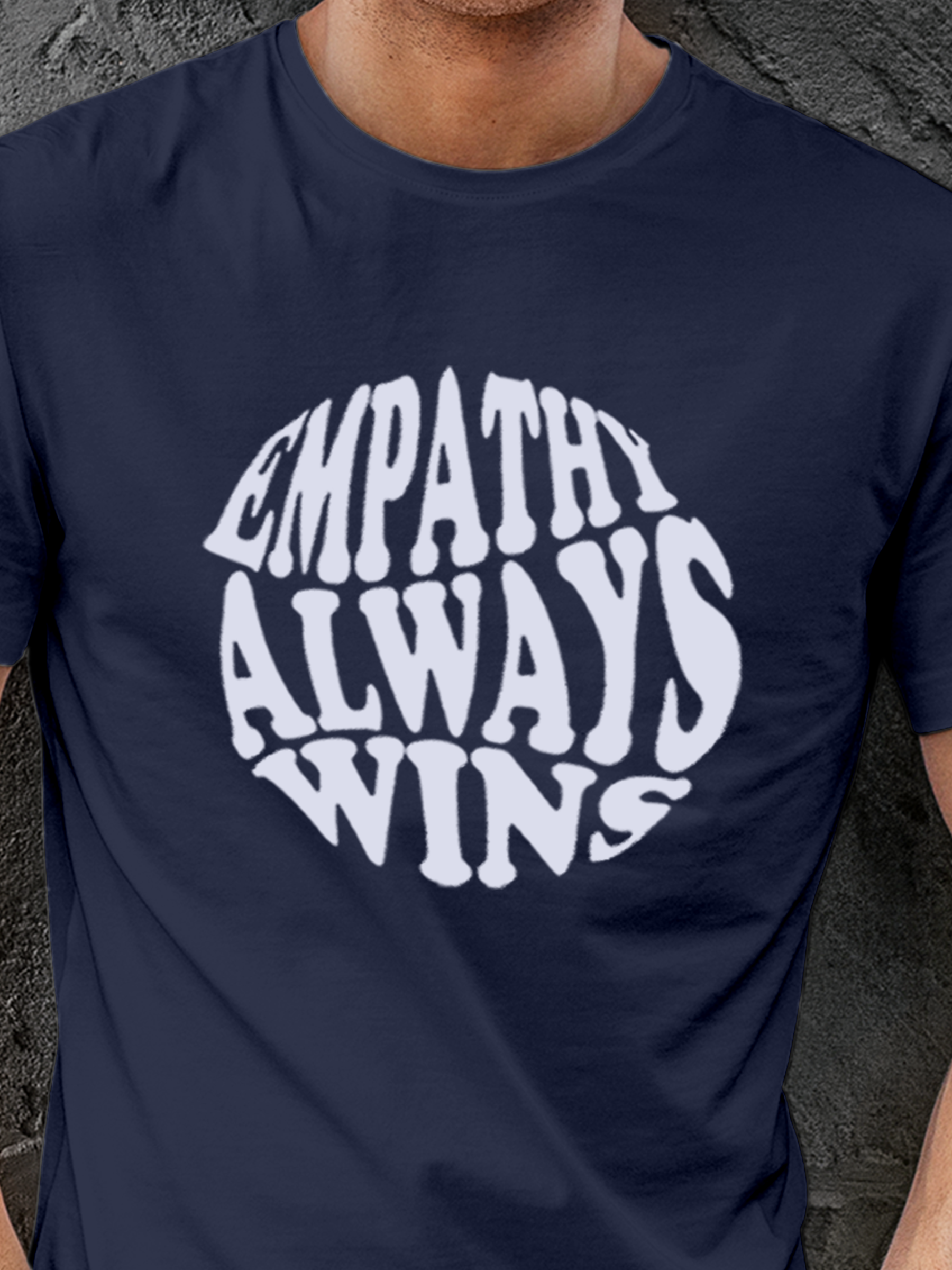 Close up of 'Empathy Always Wins' design on Men's Navy Blue Round Neck T-shirt, highlighting intricate details and vibrant print.