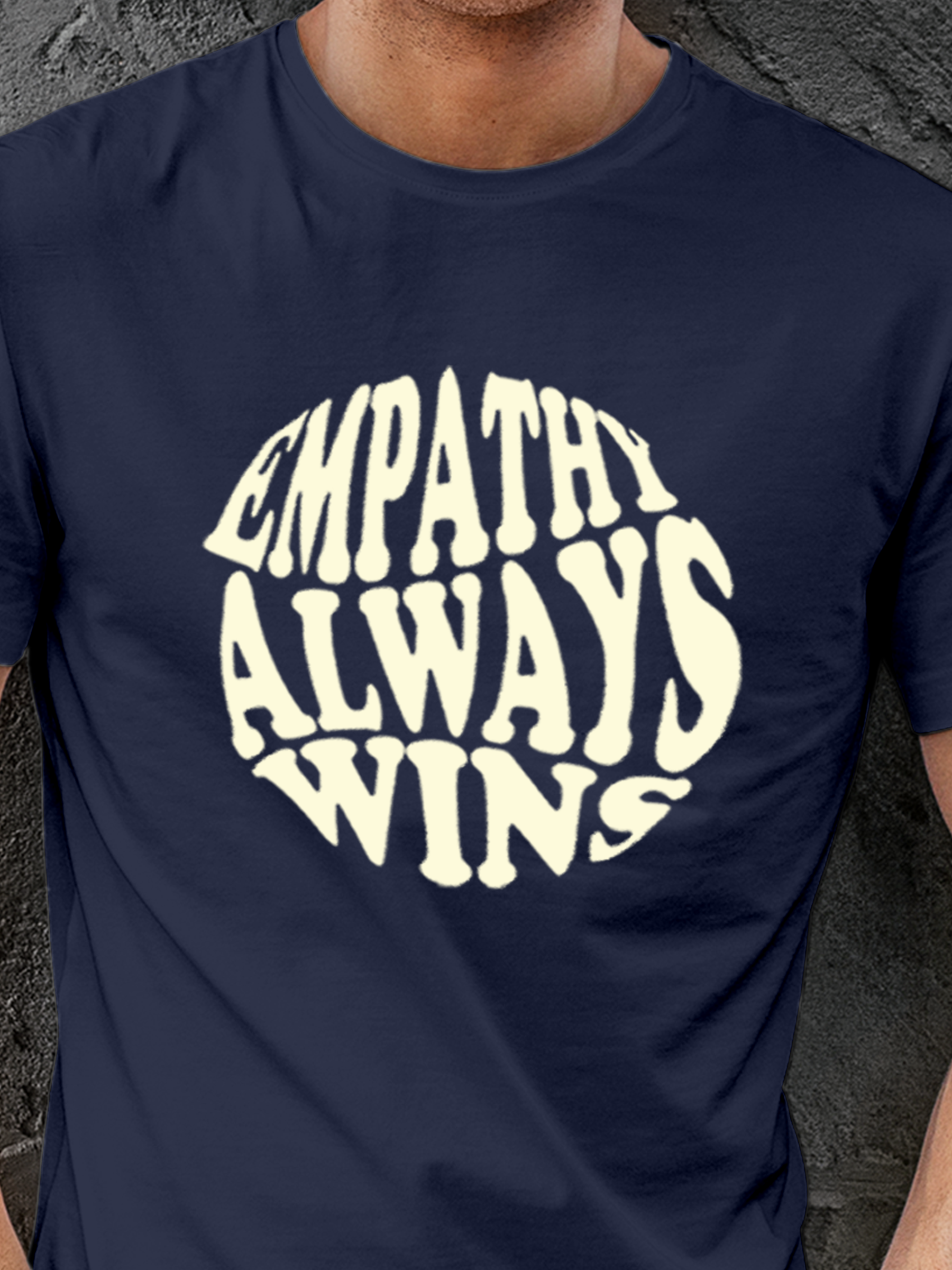 Close up of 'Empathy Always Wins' design on Men's Navy Blue Round Neck T-shirt, highlighting intricate details and vibrant print.