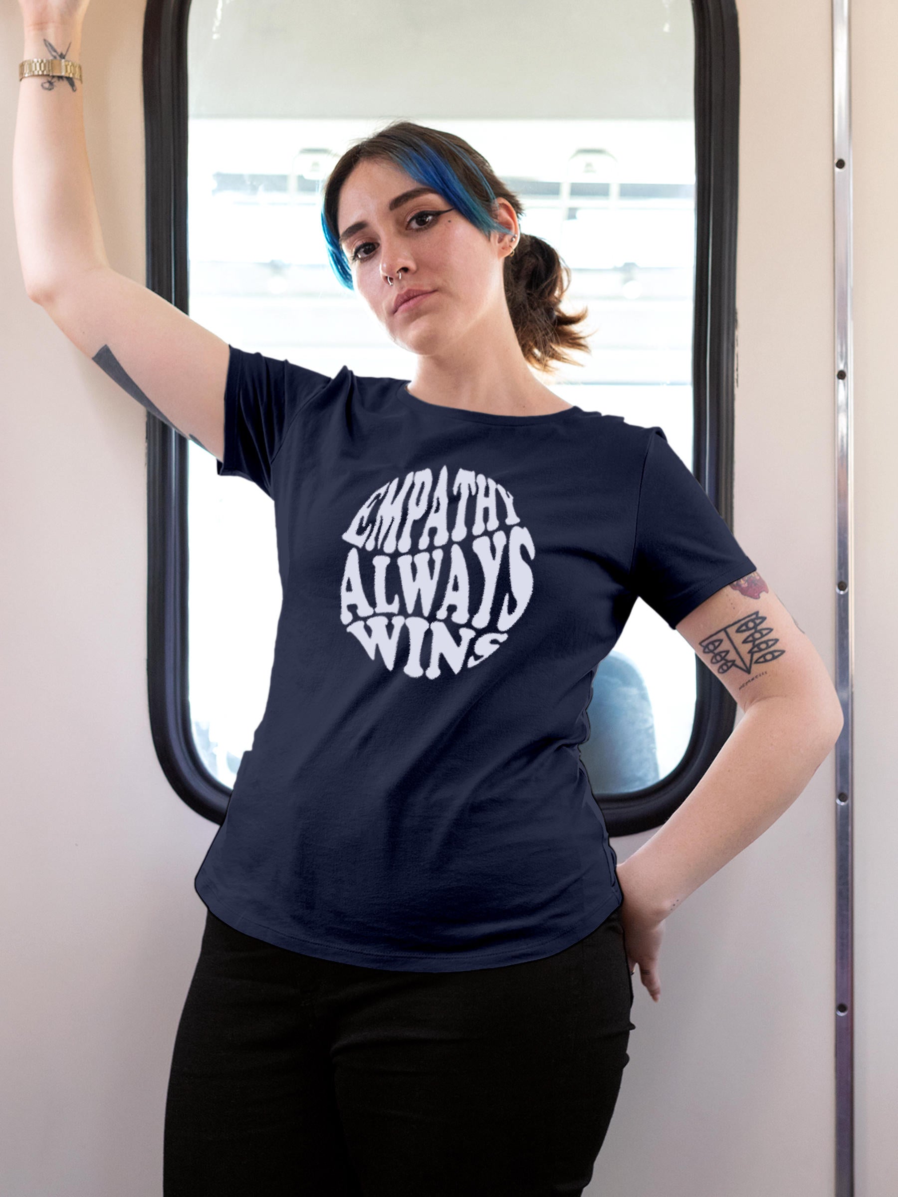 Model wearing Women's Navy Blue Round Neck T-shirt with 'Empathy Always Wins' design, offering effortless style and premium comfort