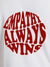 Close up of 'Empathy Always Wins' design on Men's White Round Neck T-shirt, highlighting intricate details and vibrant print.