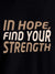 Close up of 'In Hope, Find Your Strength' design on Men's Black Round Neck T-shirt, highlighting intricate details and vibrant print.