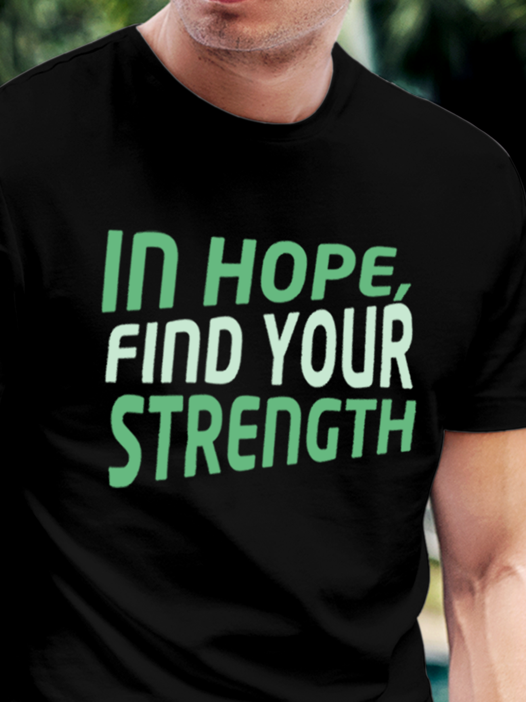 Close up of 'In Hope, Find Your Strength' design on Men's Black Round Neck T-shirt, highlighting intricate details and vibrant print.