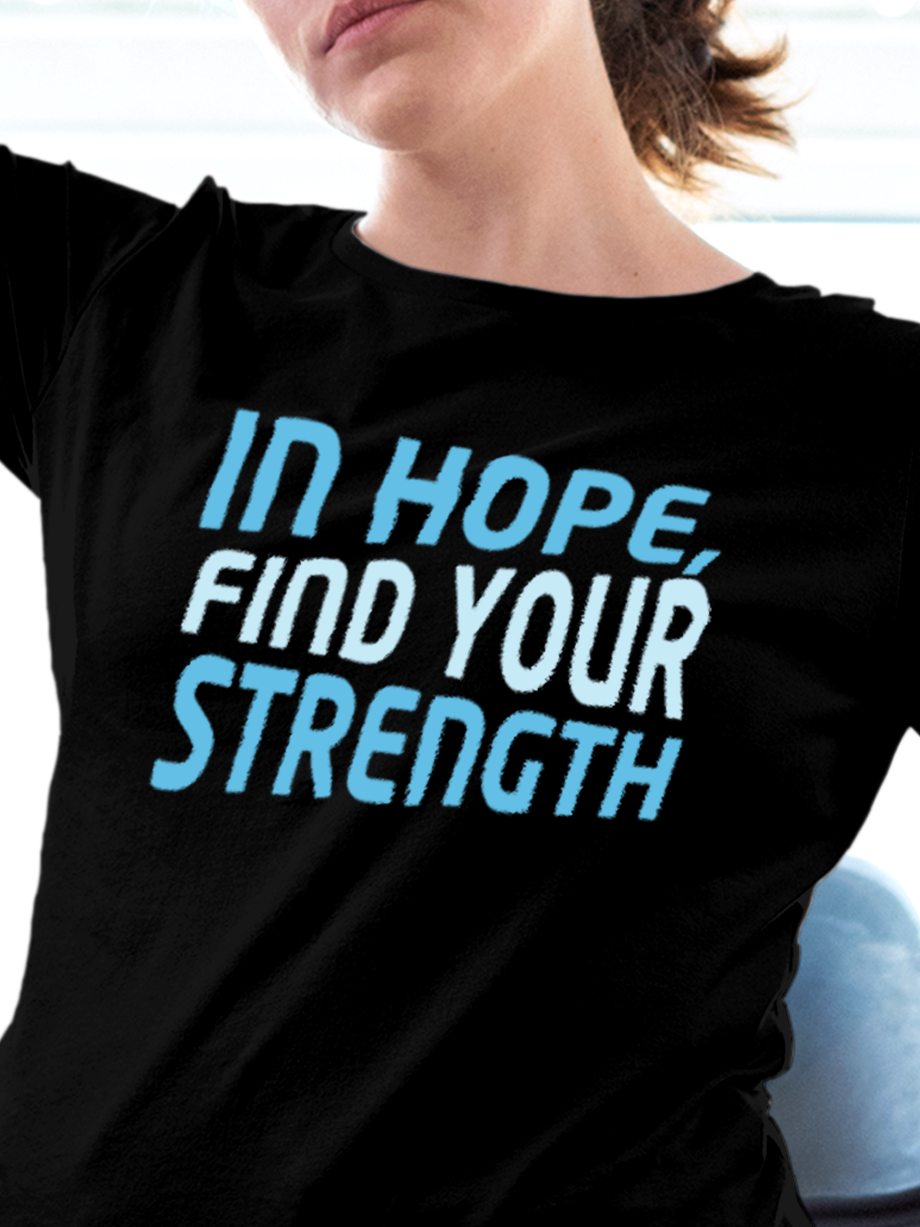 Close up of 'In Hope, Find Your Strength' design on Women's Black Round Neck T-shirt, highlighting intricate details and vibrant print.