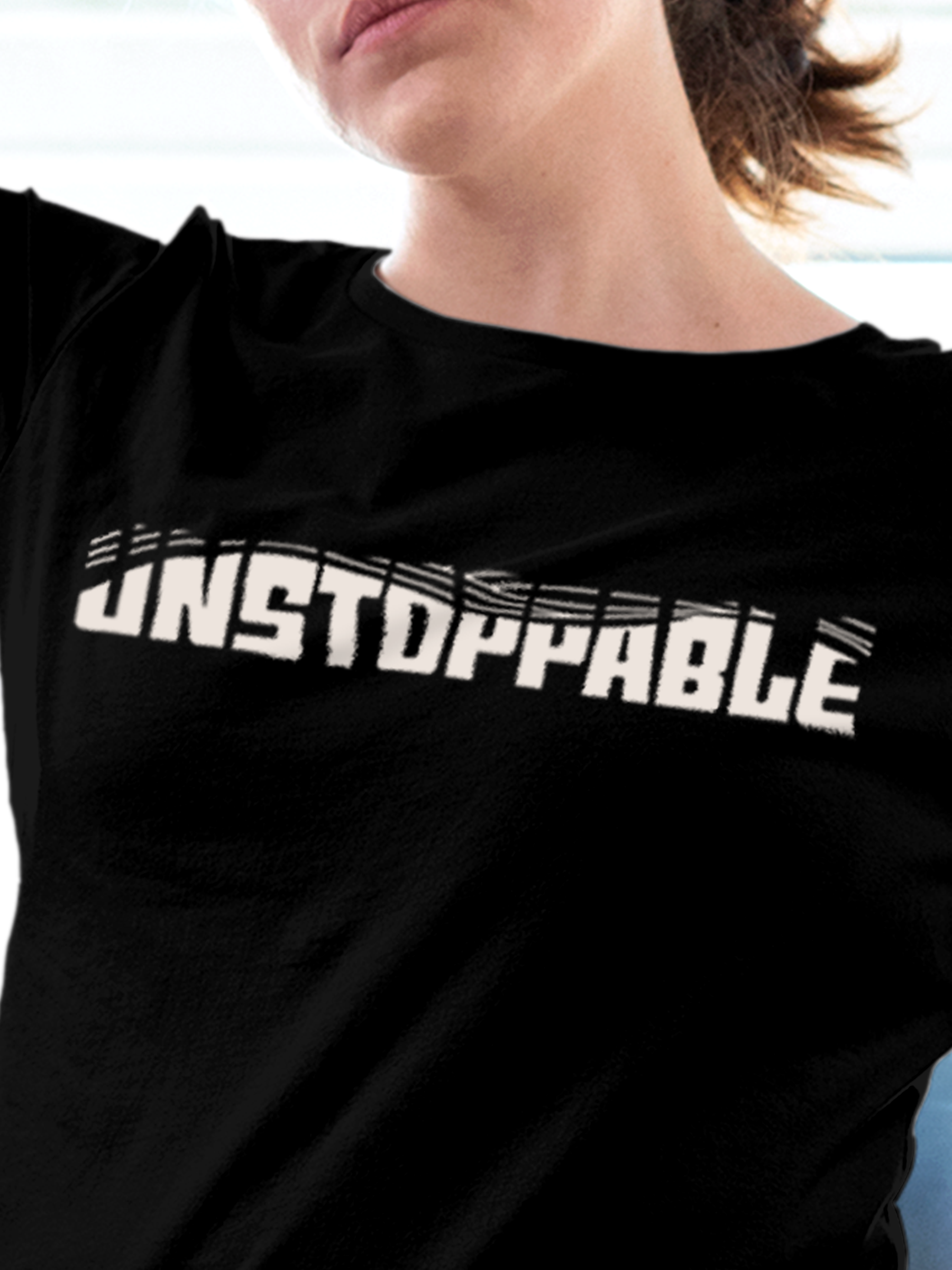 Close up of 'Unstoppable' design on Women's Black Round Neck T-shirt, highlighting intricate details and vibrant print.