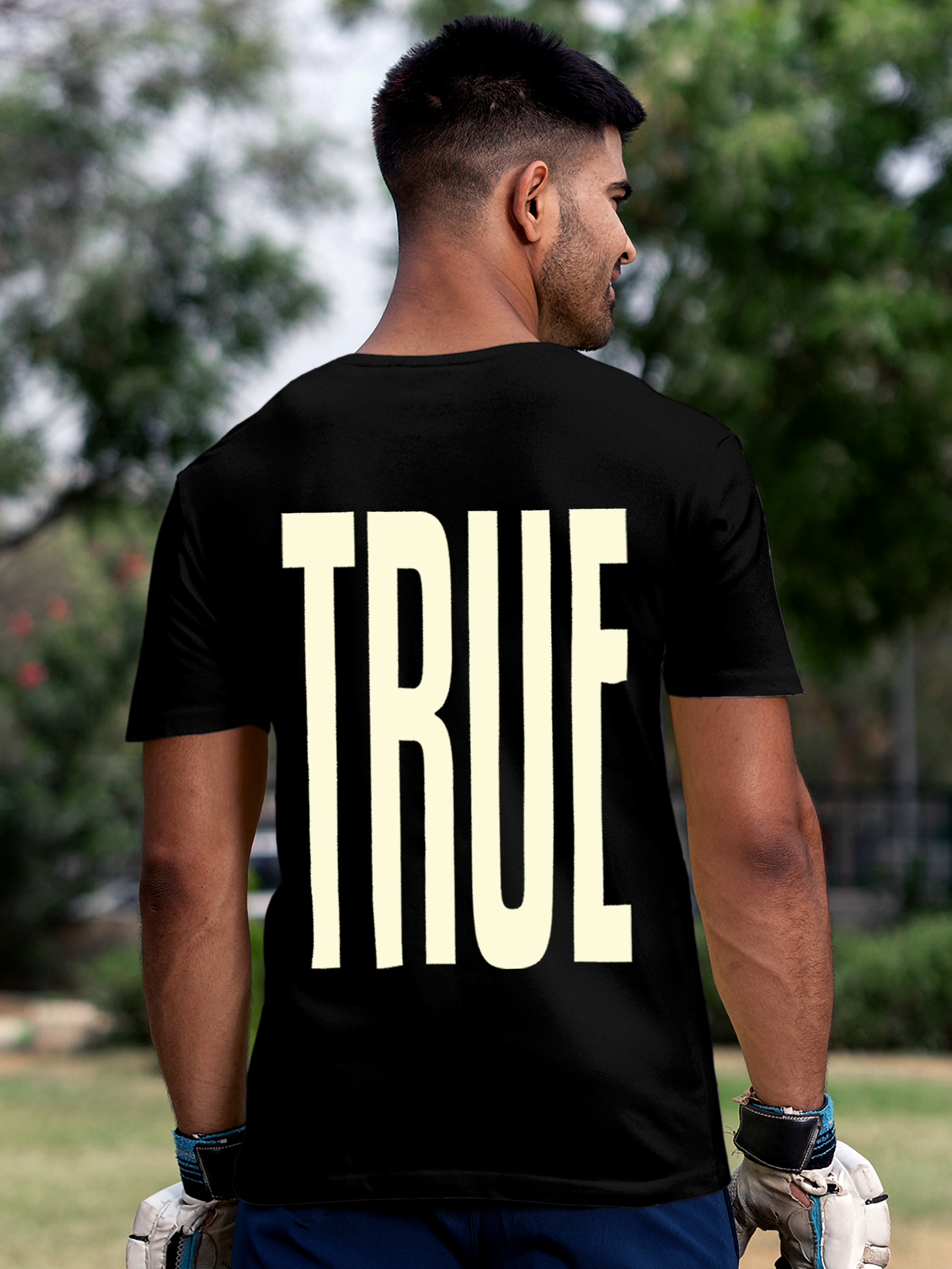 Model wearing Men's Black Round Neck T-shirt with 'Truth' design, offering effortless style and premium comfort