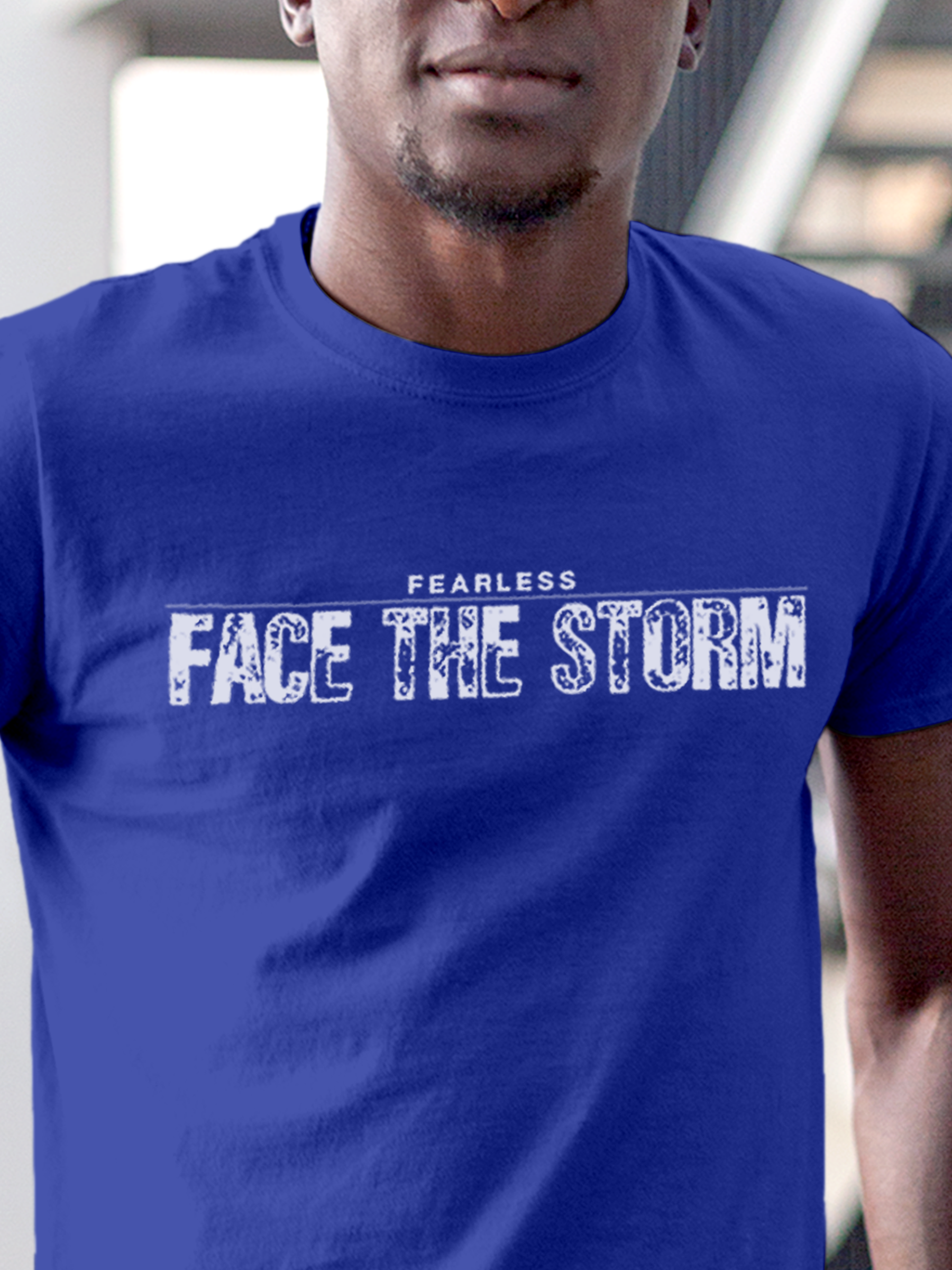 Close up of 'Fearless. Face the Storm' design on Men's Blue Round Neck T-shirt, highlighting intricate details and vibrant print.
