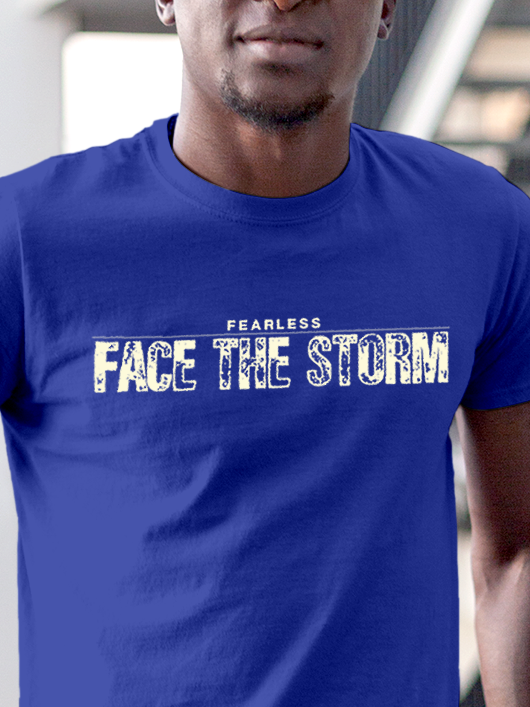Close up of 'Fearless. Face the Storm' design on Men's Blue Round Neck T-shirt, highlighting intricate details and vibrant print.