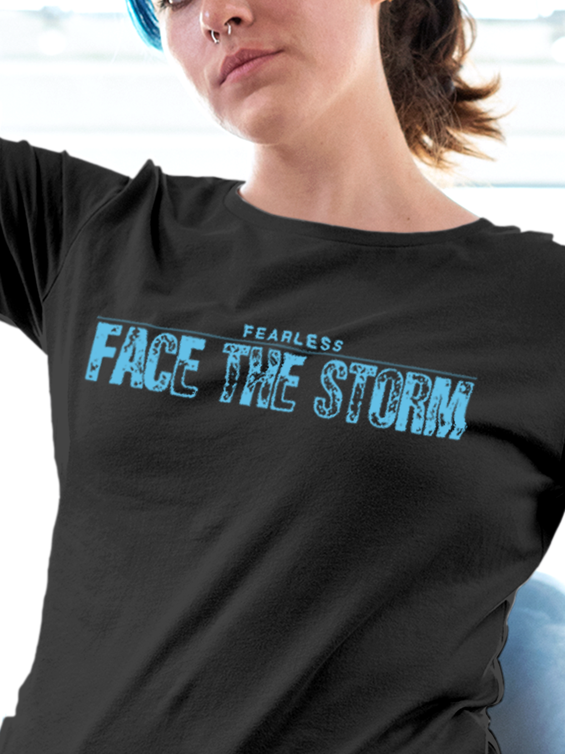 Close up of 'Fearless. Face the Storm' design on Women's Dark Grey Round Neck T-shirt, highlighting intricate details and vibrant print.