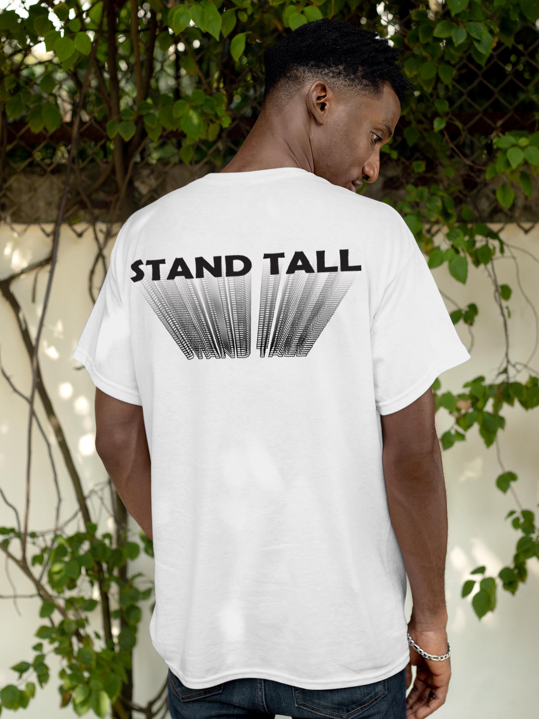 Model wearing Men's White Round Neck T-shirt with 'Stand Tall' design, offering effortless style and premium comfort