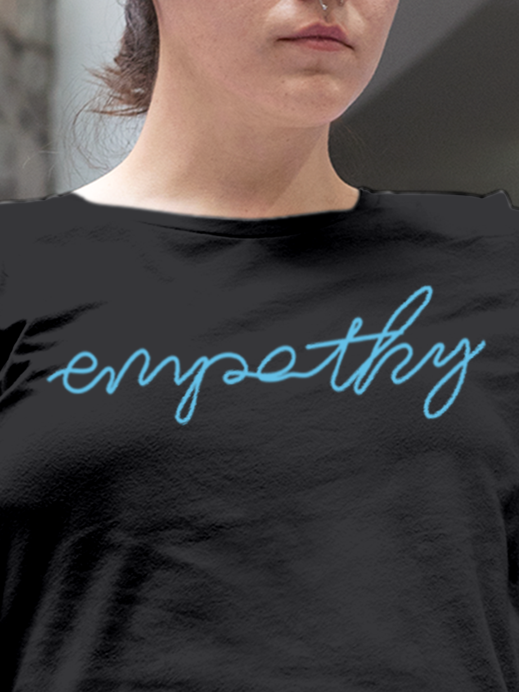 Close up of 'Empathy' design on Women's Charcoal Grey Round Neck T-shirt, highlighting intricate details and vibrant print.