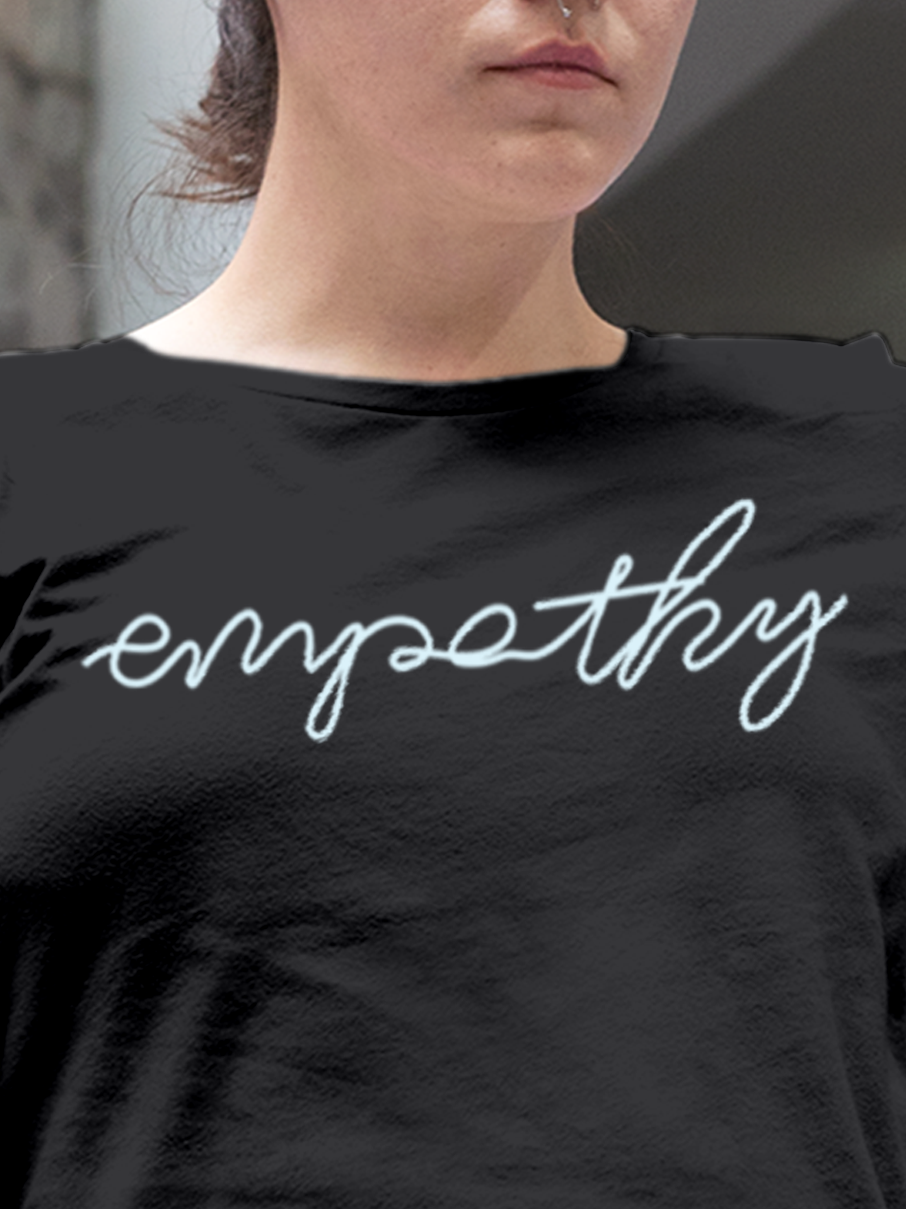 Close up of 'Empathy' design on Women's Charcoal Grey Round Neck T-shirt, highlighting intricate details and vibrant print.