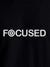 Close up of 'Focused' design on Men's Black Round Neck T-shirt, highlighting intricate details and vibrant print.