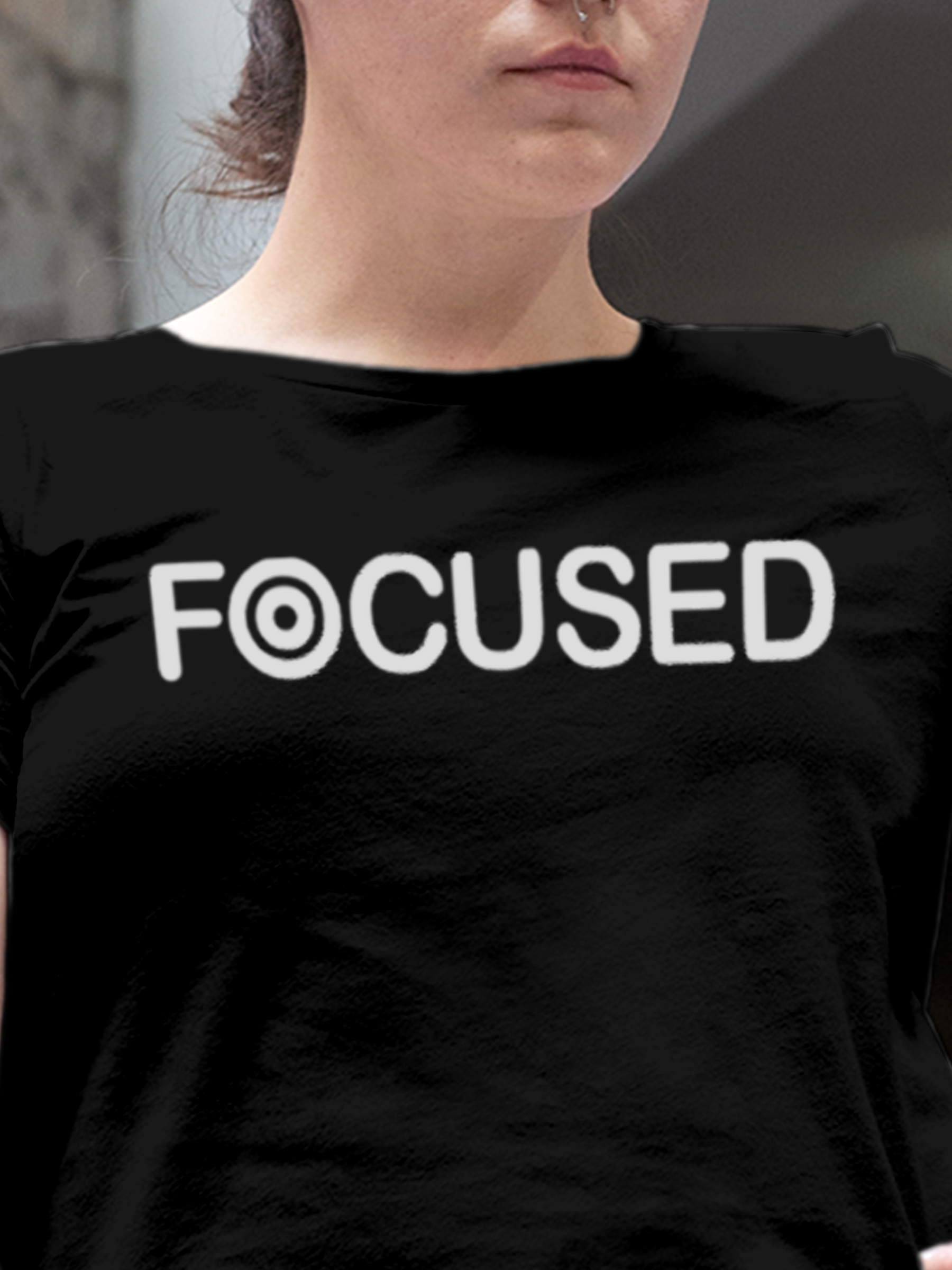 Close up of 'Focused' design on Women's Black Round Neck T-shirt, highlighting intricate details and vibrant print.