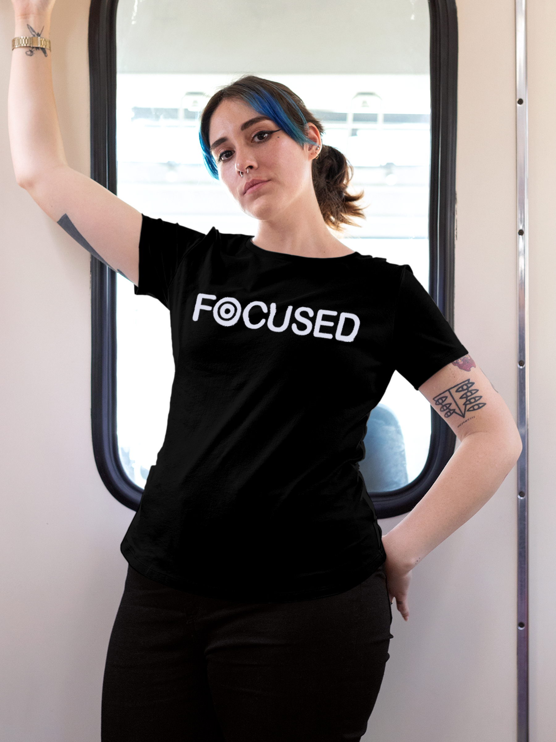 Model wearing Women's Black Round Neck T-shirt with 'Focused' design, offering effortless style and premium comfort