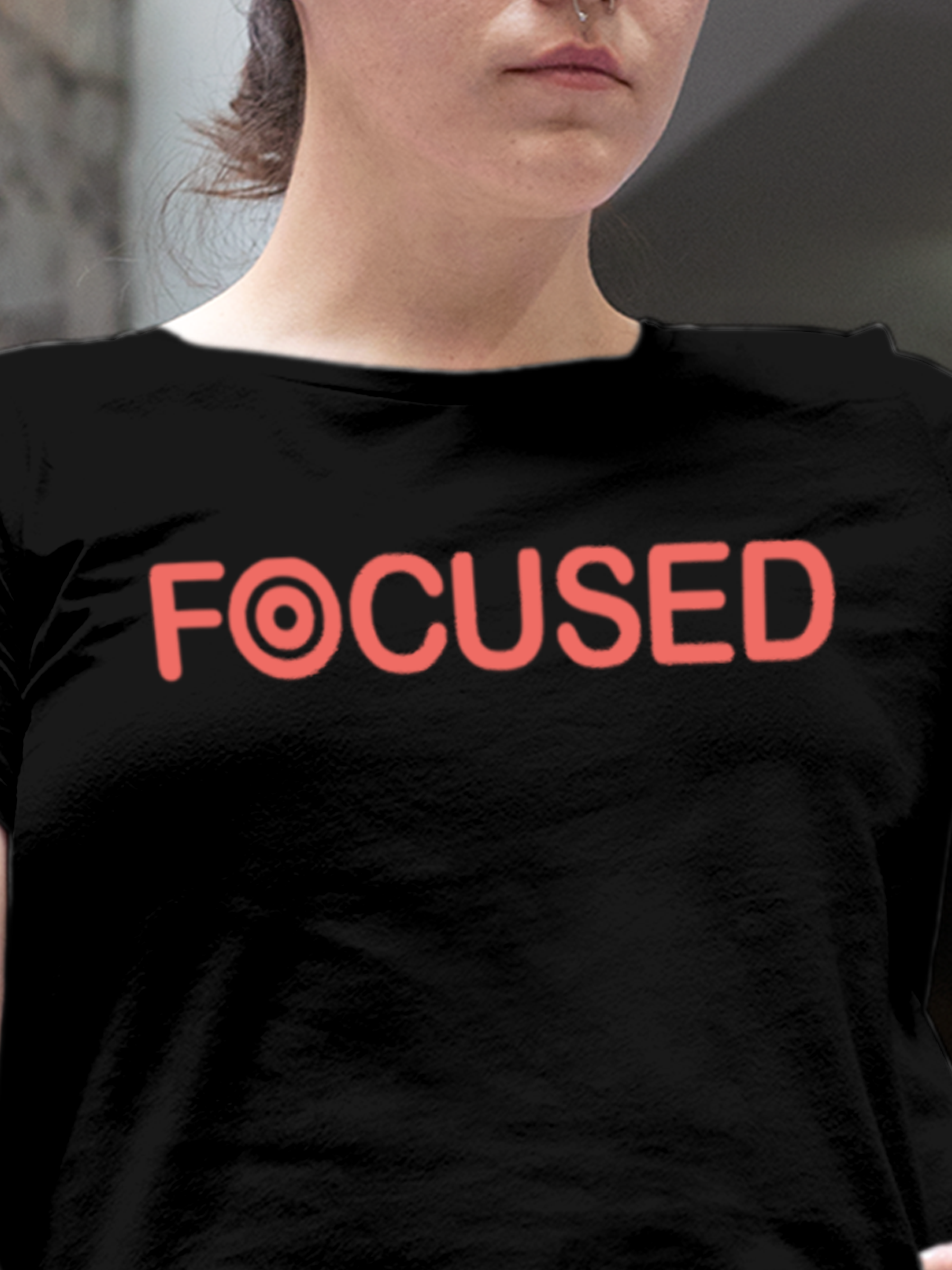 Close up of 'Focused' design on Women's Black Round Neck T-shirt, highlighting intricate details and vibrant print.