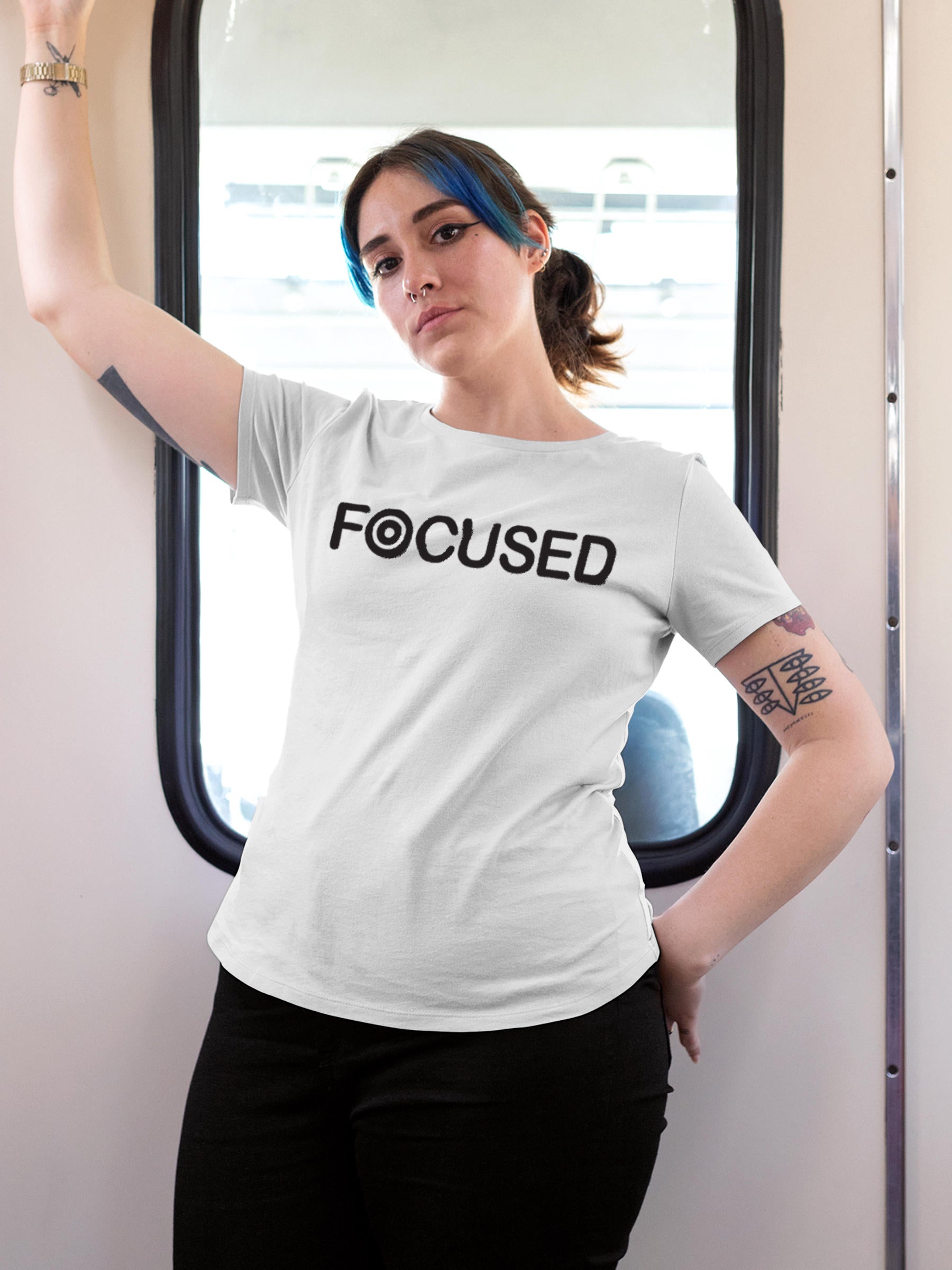 Model wearing Women's White Round Neck T-shirt with 'Focused' design, offering effortless style and premium comfort