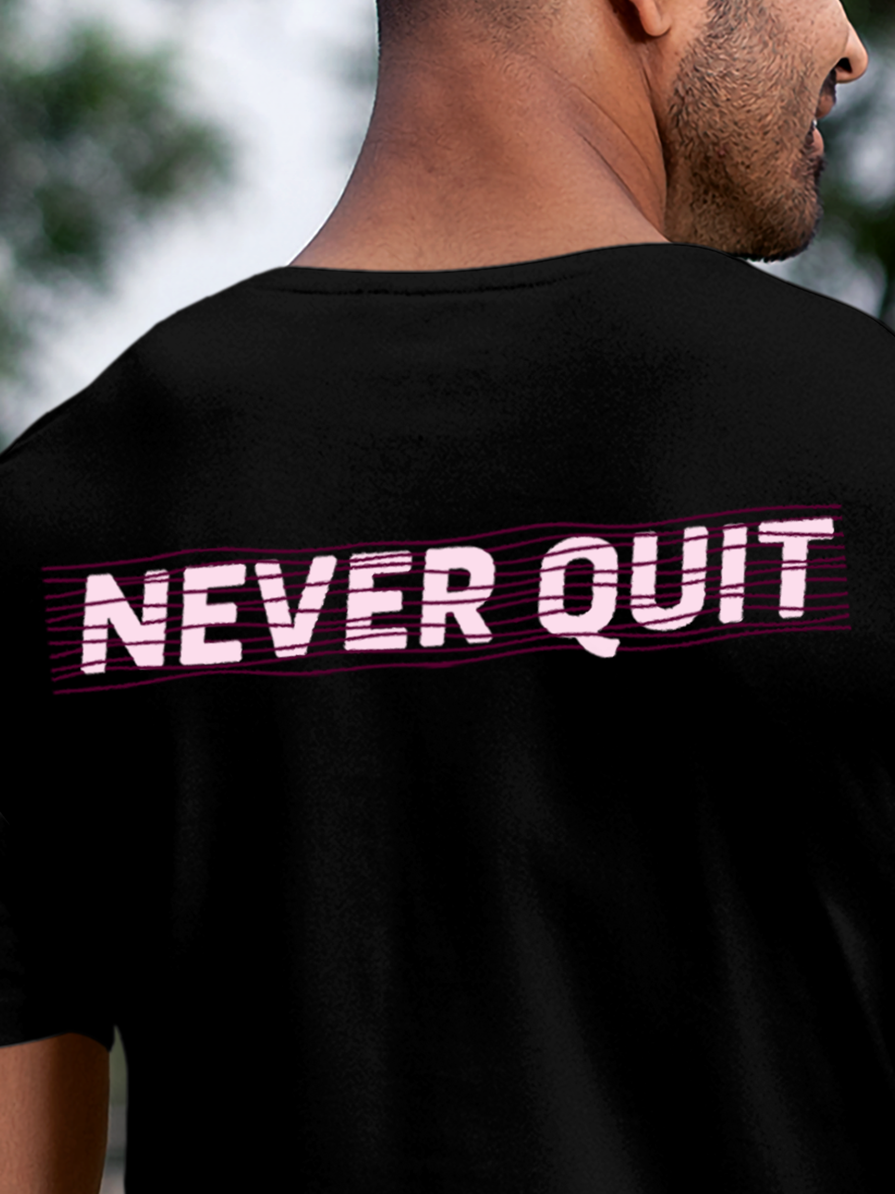 Close up of 'Never Quit' design on Men's Black Round Neck T-shirt, highlighting intricate details and vibrant print.