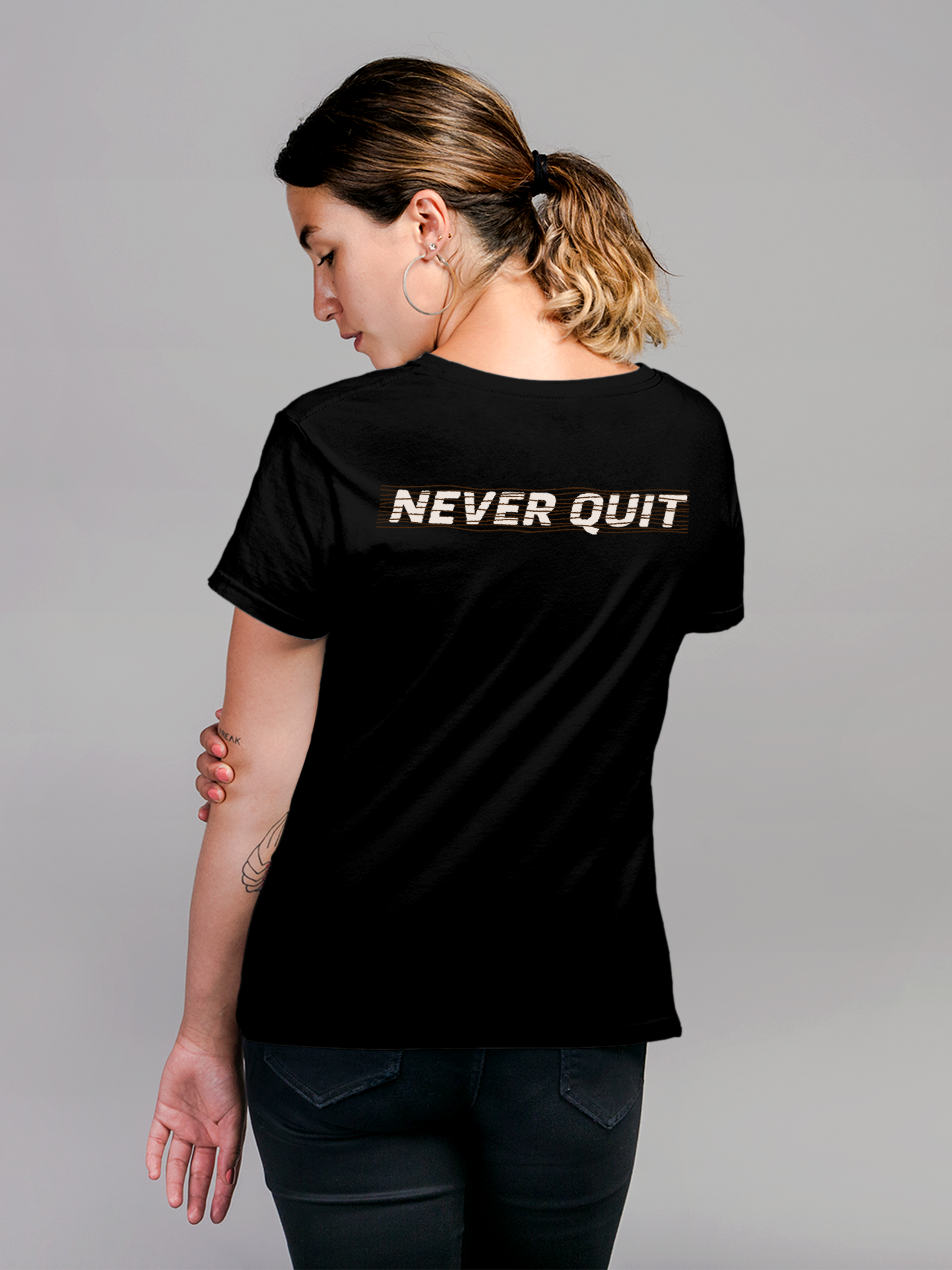 Model wearing Women's Black Round Neck T-shirt with 'Never Quit' design, offering effortless style and premium comfort