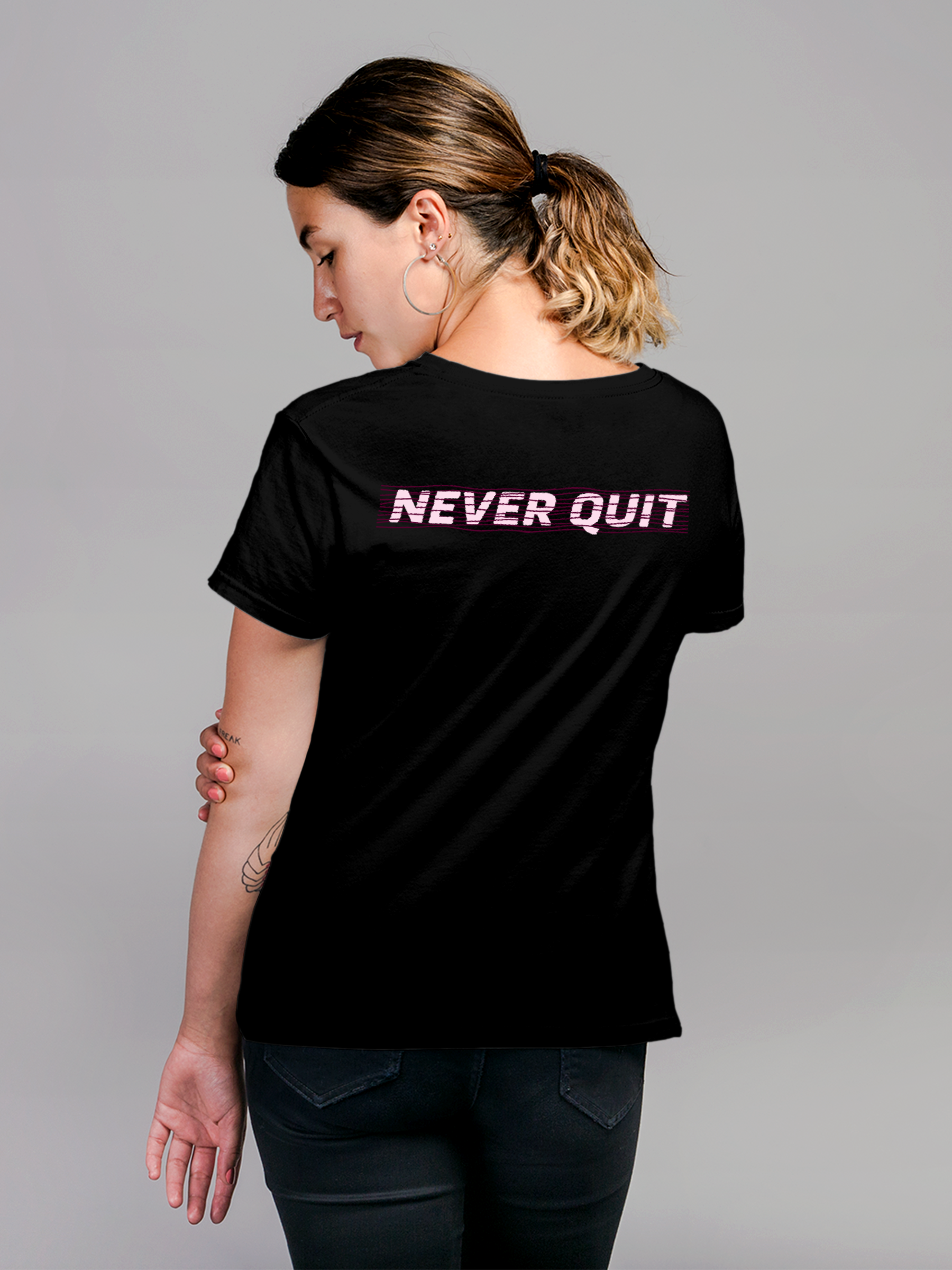 Model wearing Women's Black Round Neck T-shirt with 'Never Quit' design, offering effortless style and premium comfort