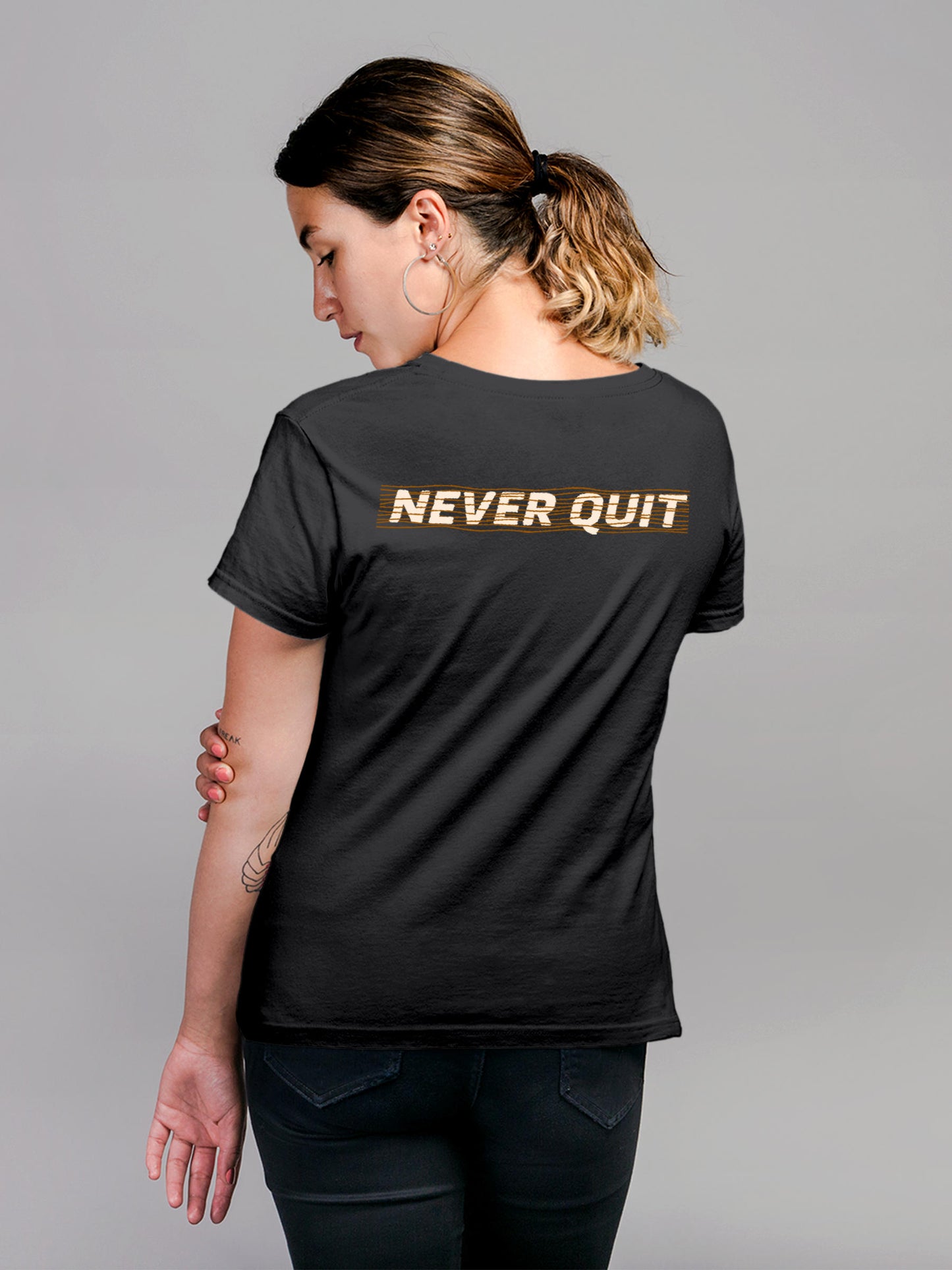 Model wearing Women's Dark Grey Round Neck T-shirt with 'Never Quit' design, offering effortless style and premium comfort