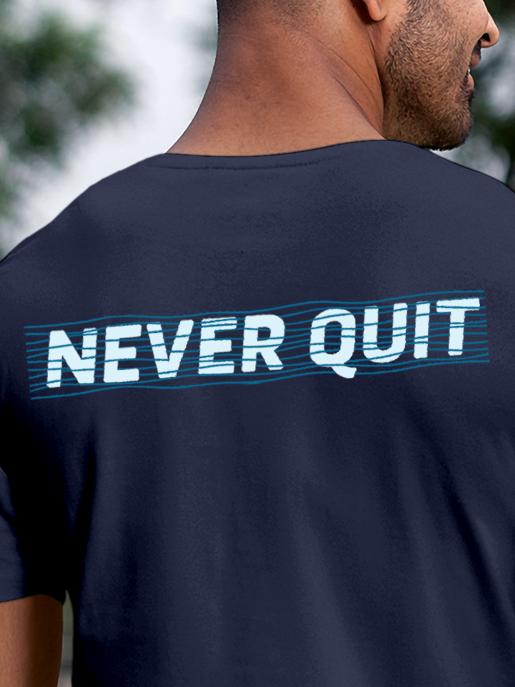 Close up of 'Never Quit' design on Men's Navy Blue Round Neck T-shirt, highlighting intricate details and vibrant print.