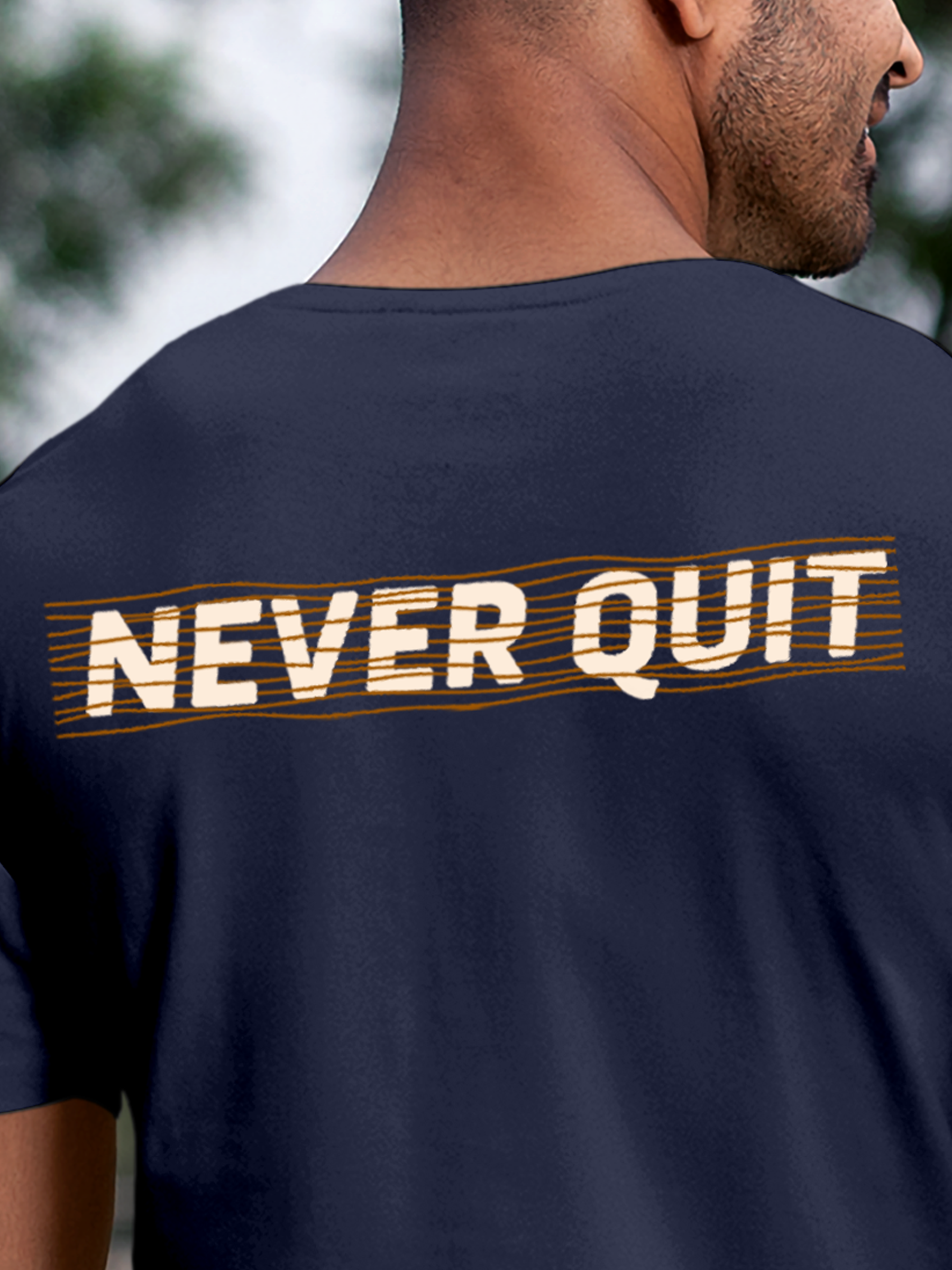 Close up of 'Never Quit' design on Men's Navy Blue Round Neck T-shirt, highlighting intricate details and vibrant print.