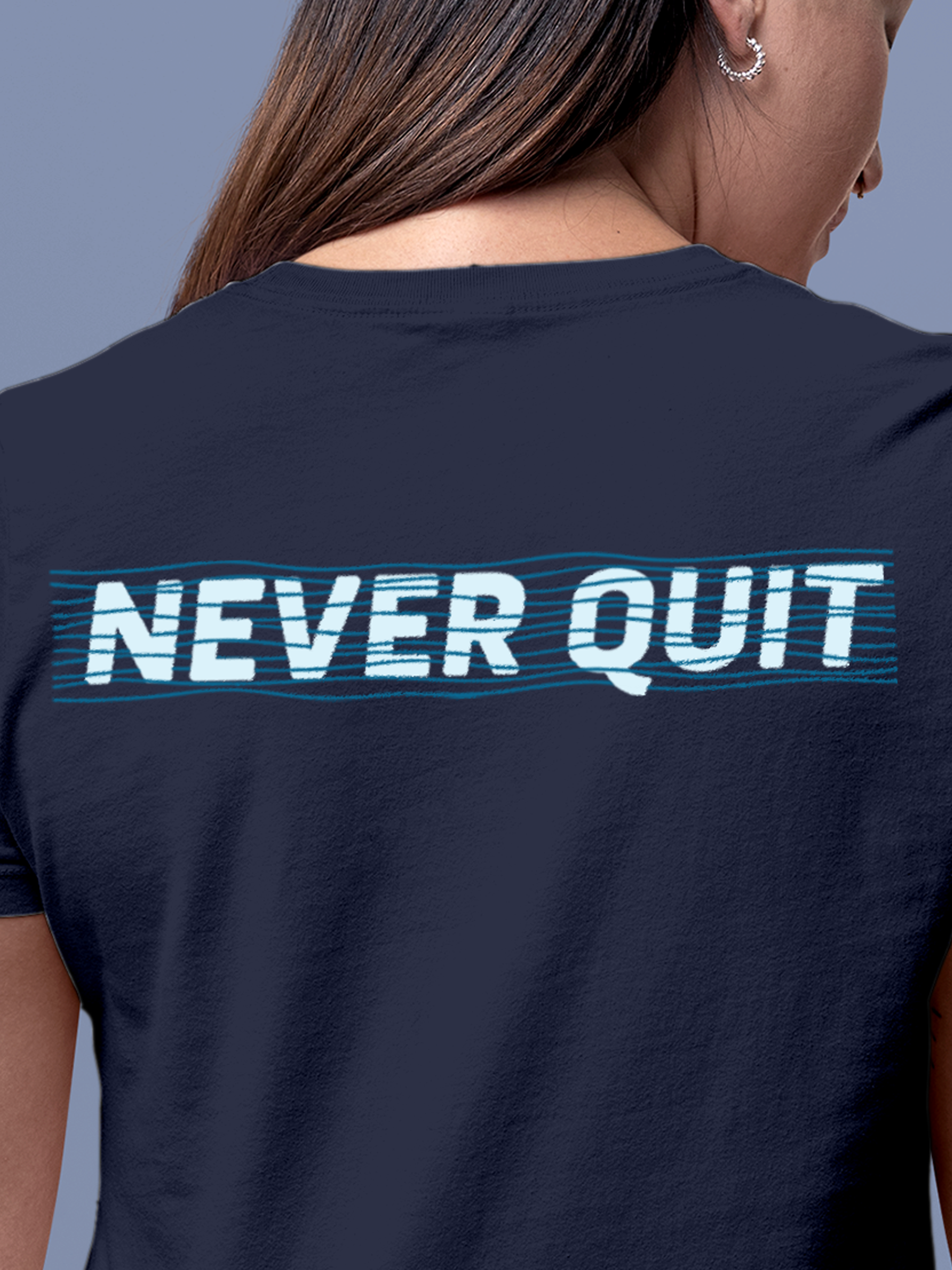 Close up of 'Never Quit' design on Women's Navy Blue Round Neck T-shirt, highlighting intricate details and vibrant print.