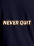 Close up of 'Never Quit' design on Women's Navy Blue Round Neck T-shirt, highlighting intricate details and vibrant print.
