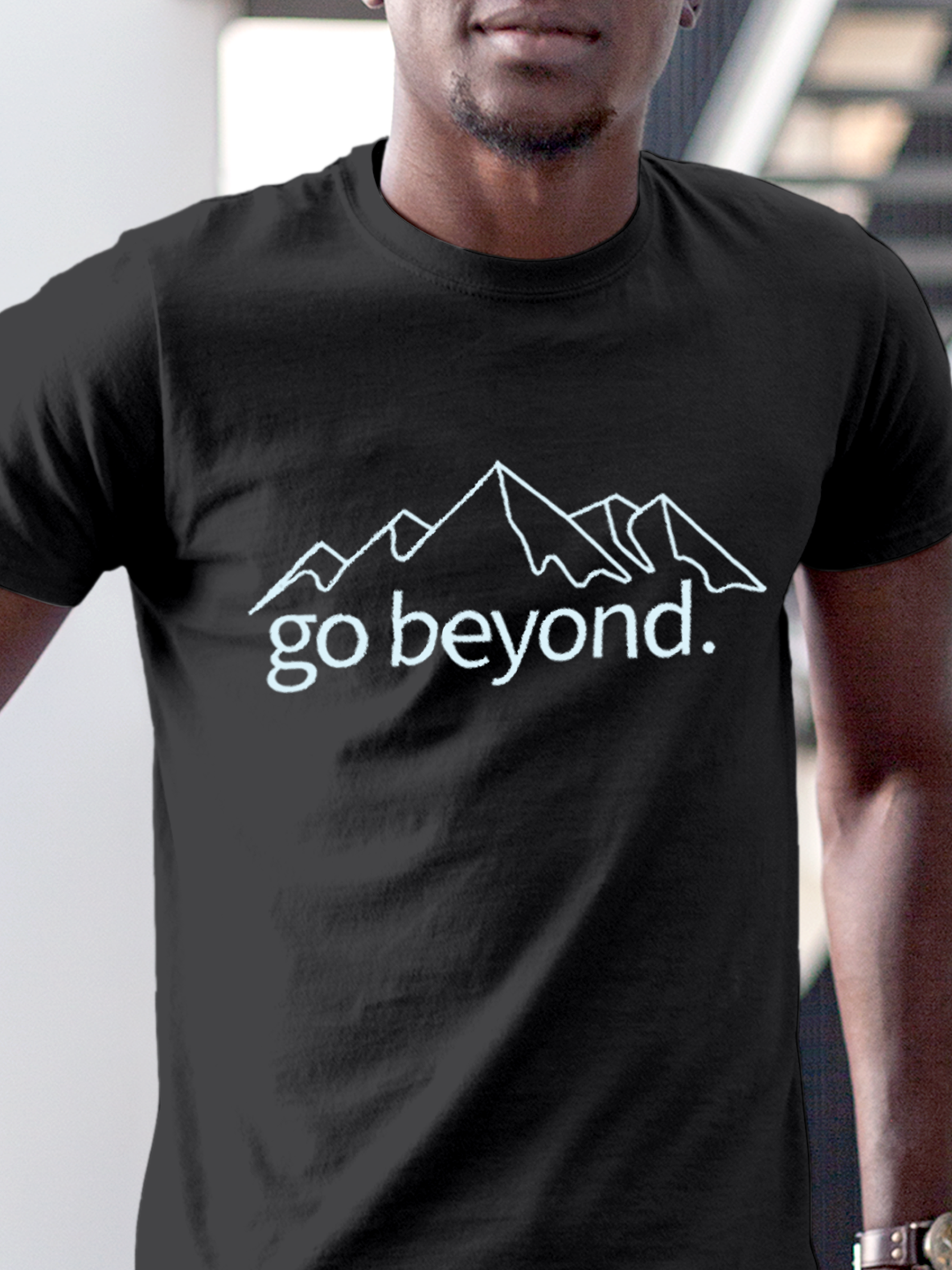 Close up of 'Go Beyond' design on Men's Charcoal Grey Round Neck T-shirt, highlighting intricate details and vibrant print.