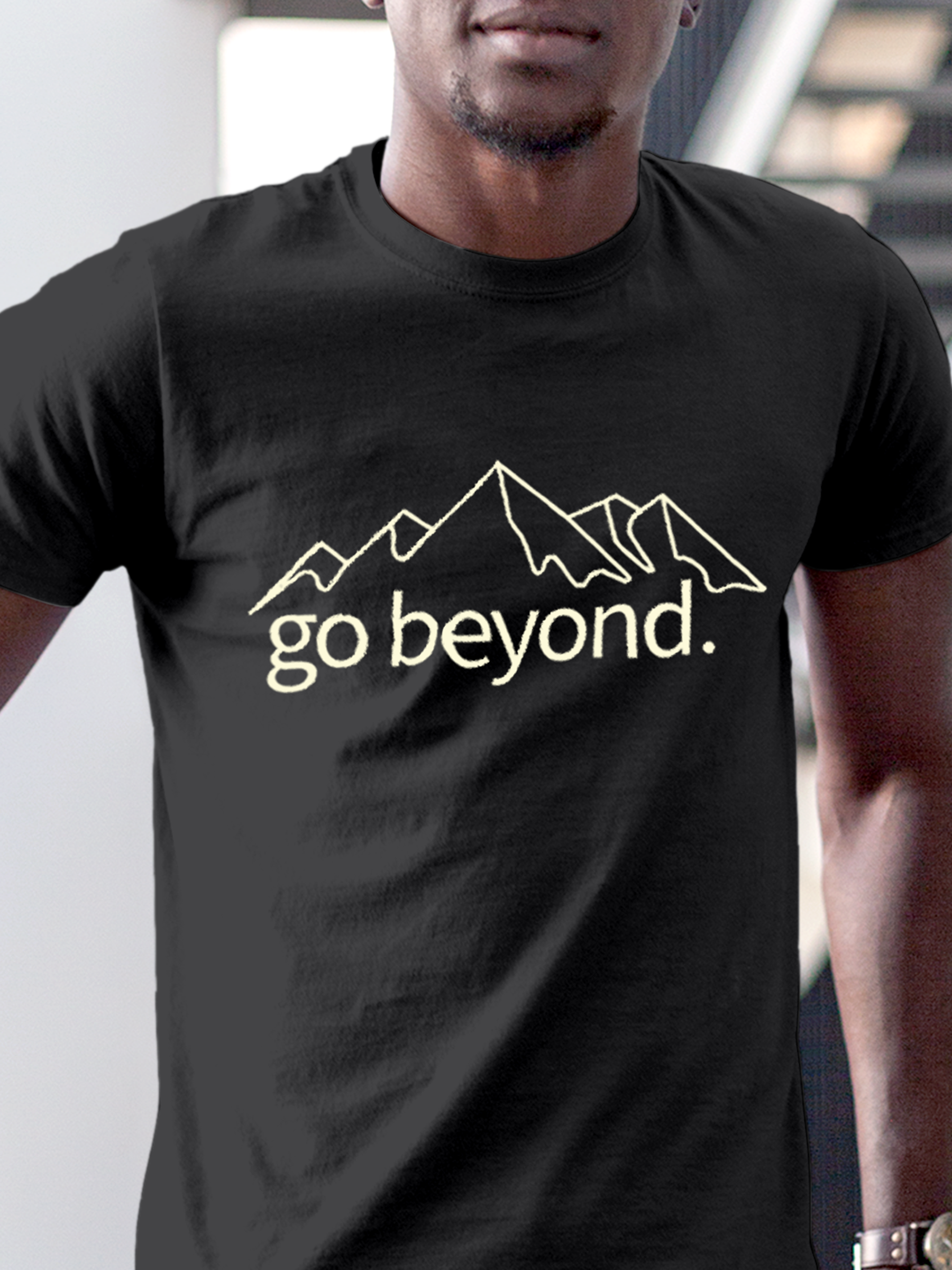 Close up of 'Go Beyond' design on Men's Charcoal Grey Round Neck T-shirt, highlighting intricate details and vibrant print.