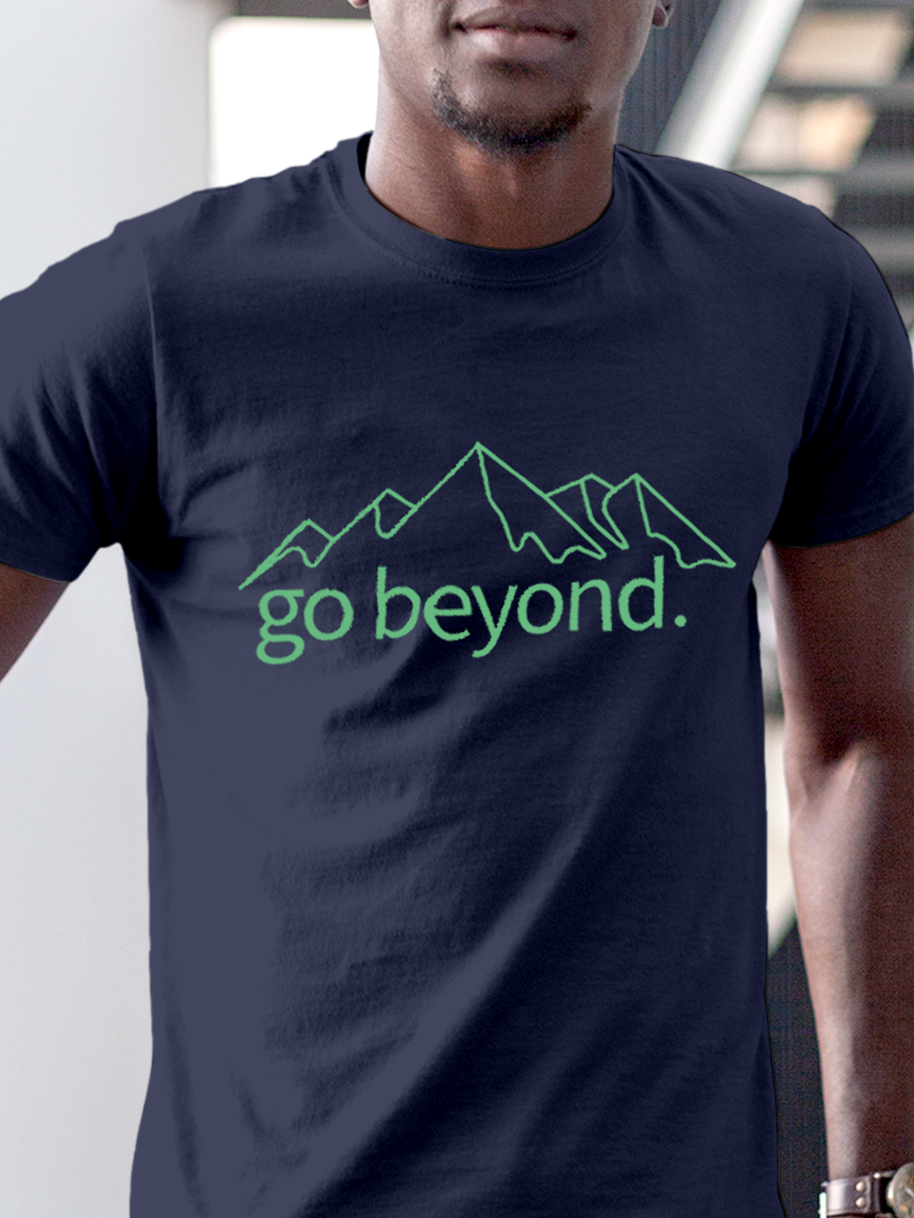 Close up of 'Go Beyond' design on Men's Navy Blue Round Neck T-shirt, highlighting intricate details and vibrant print.