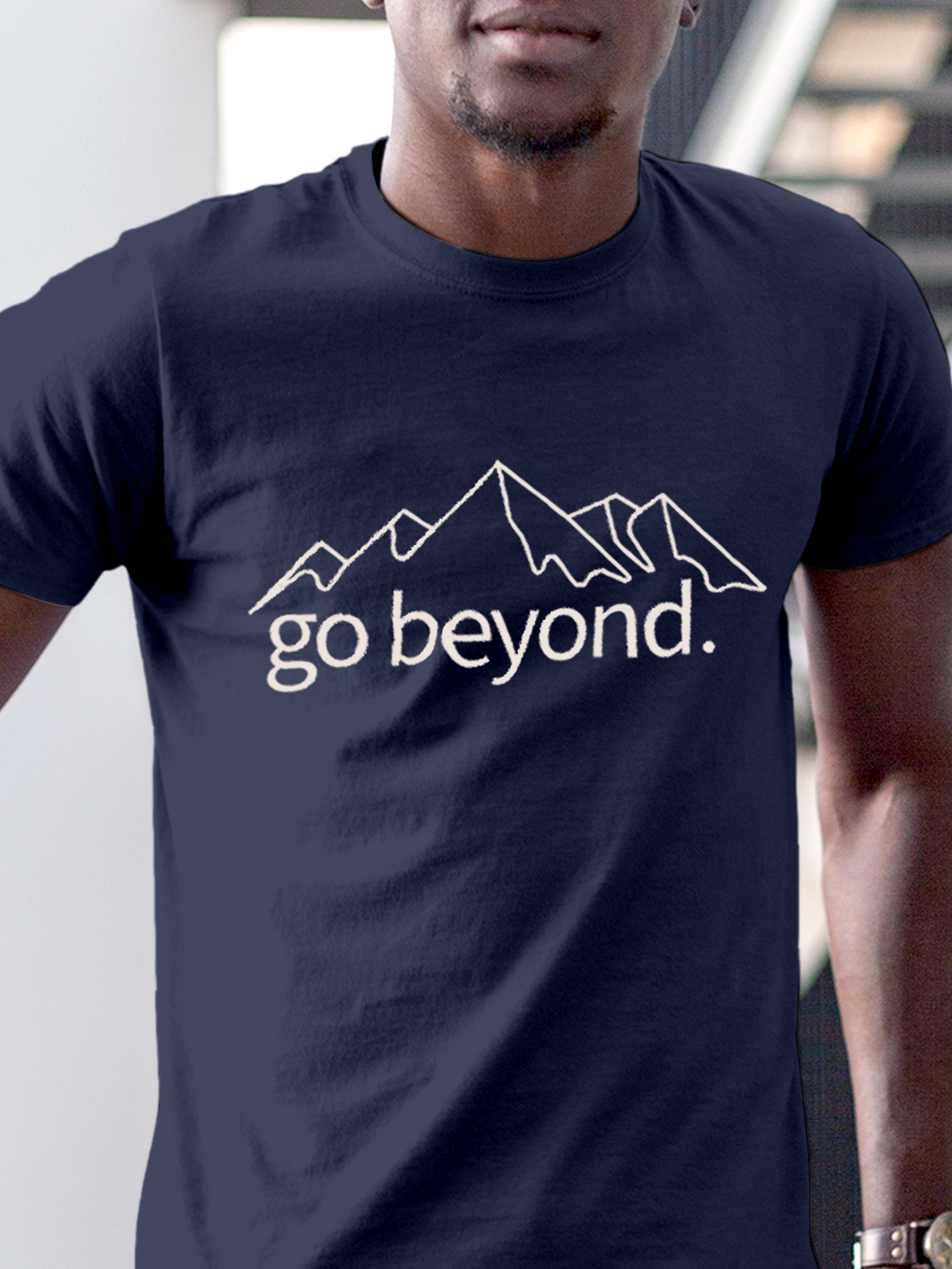 Close up of 'Go Beyond' design on Men's Navy Blue Round Neck T-shirt, highlighting intricate details and vibrant print.