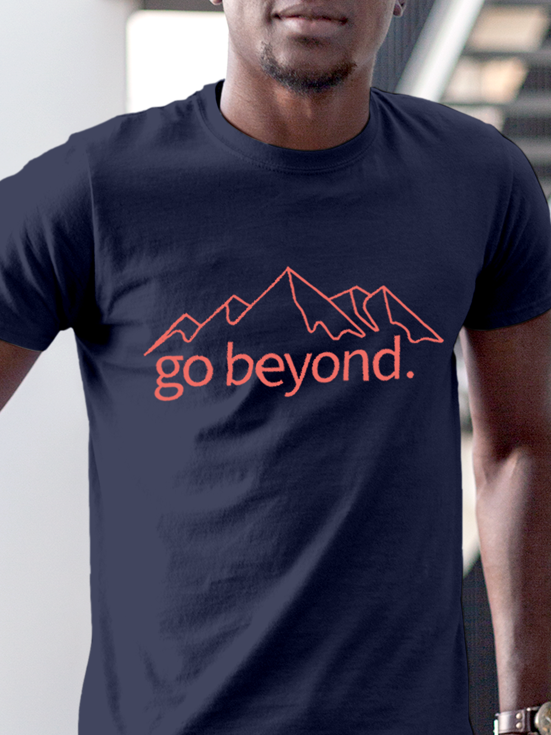 Close up of 'Go Beyond' design on Men's Navy Blue Round Neck T-shirt, highlighting intricate details and vibrant print.