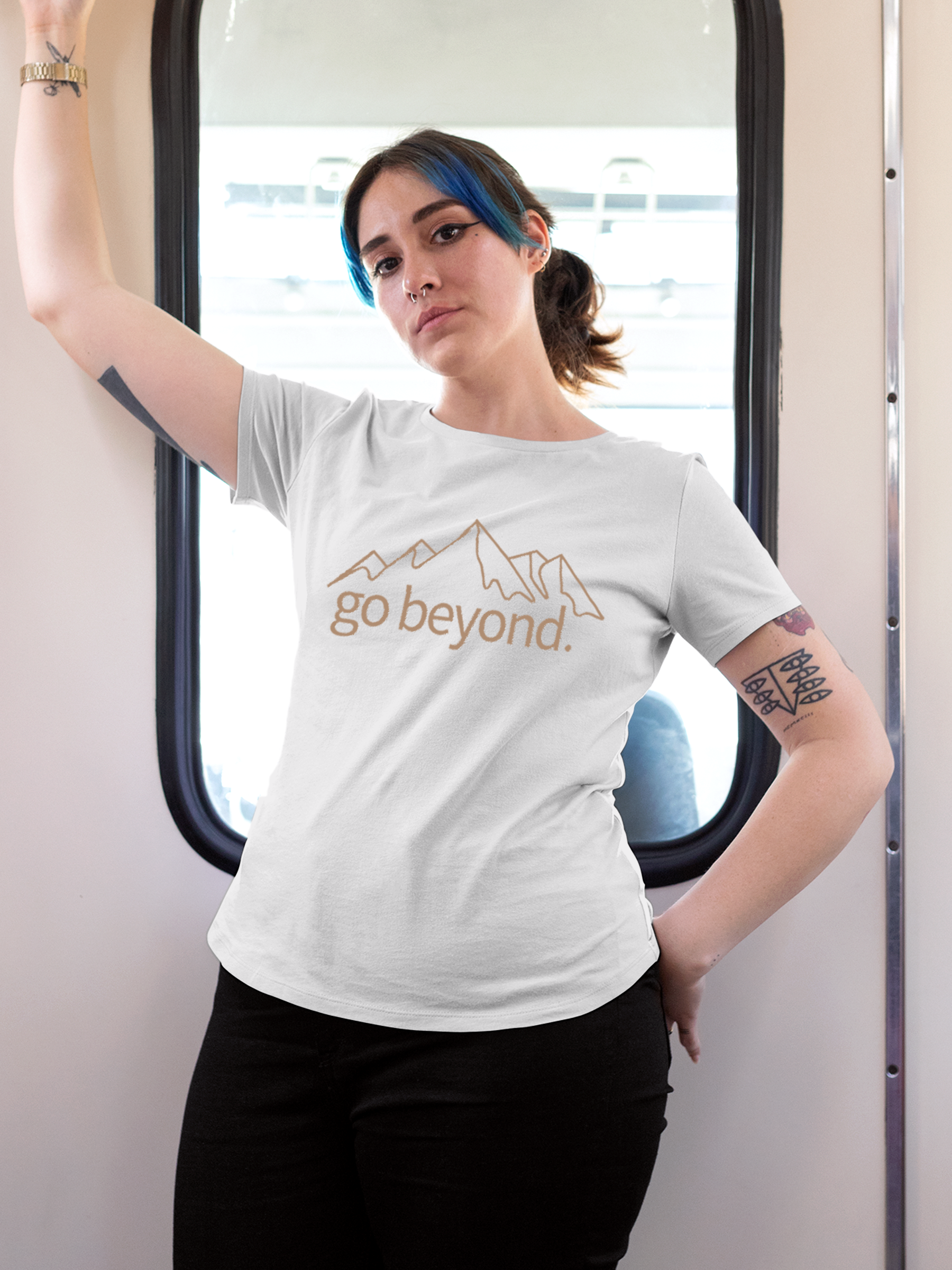 Model wearing Women's White Round Neck T-shirt with 'Go Beyond' design, offering effortless style and premium comfort