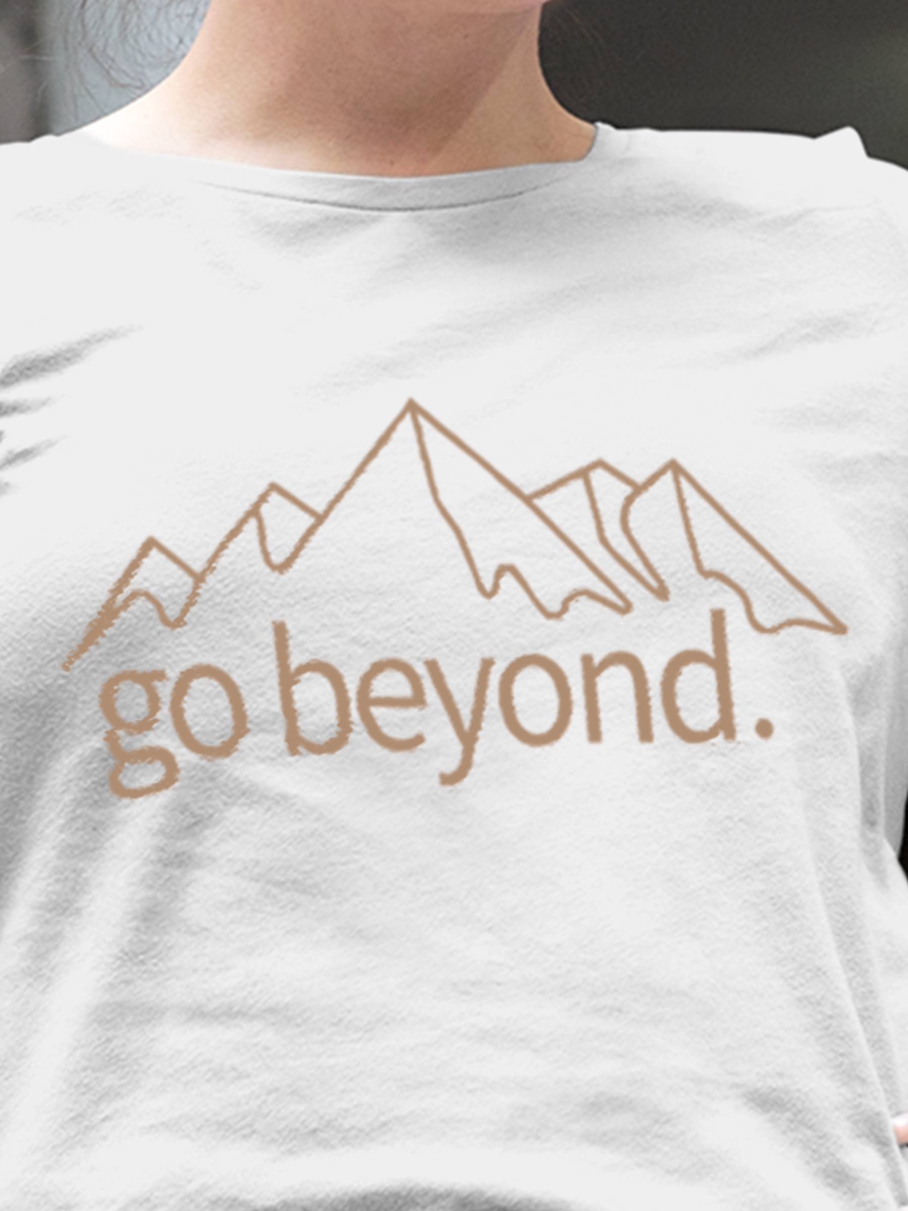 Close up of 'Go Beyond' design on Women's White Round Neck T-shirt, highlighting intricate details and vibrant print.
