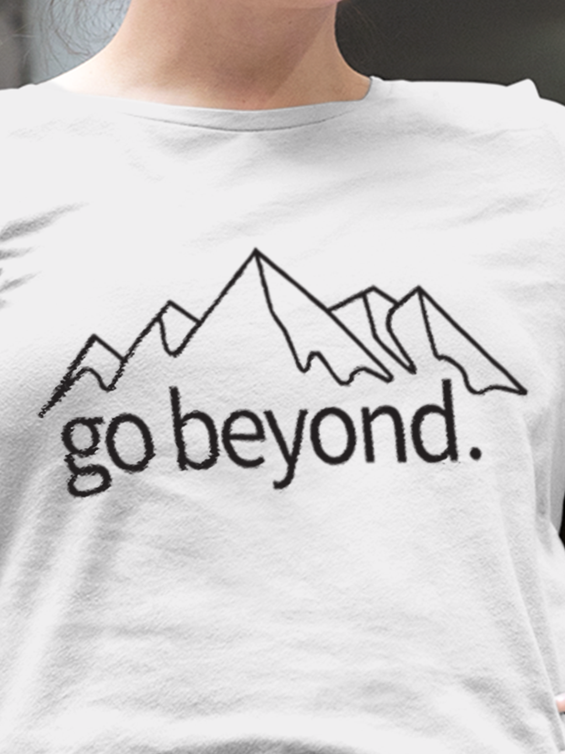 Close up of 'Go Beyond' design on Women's White Round Neck T-shirt, highlighting intricate details and vibrant print.