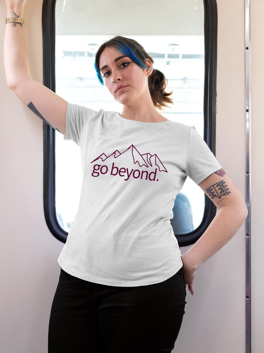 Model wearing Women's White Round Neck T-shirt with 'Go Beyond' design, offering effortless style and premium comfort