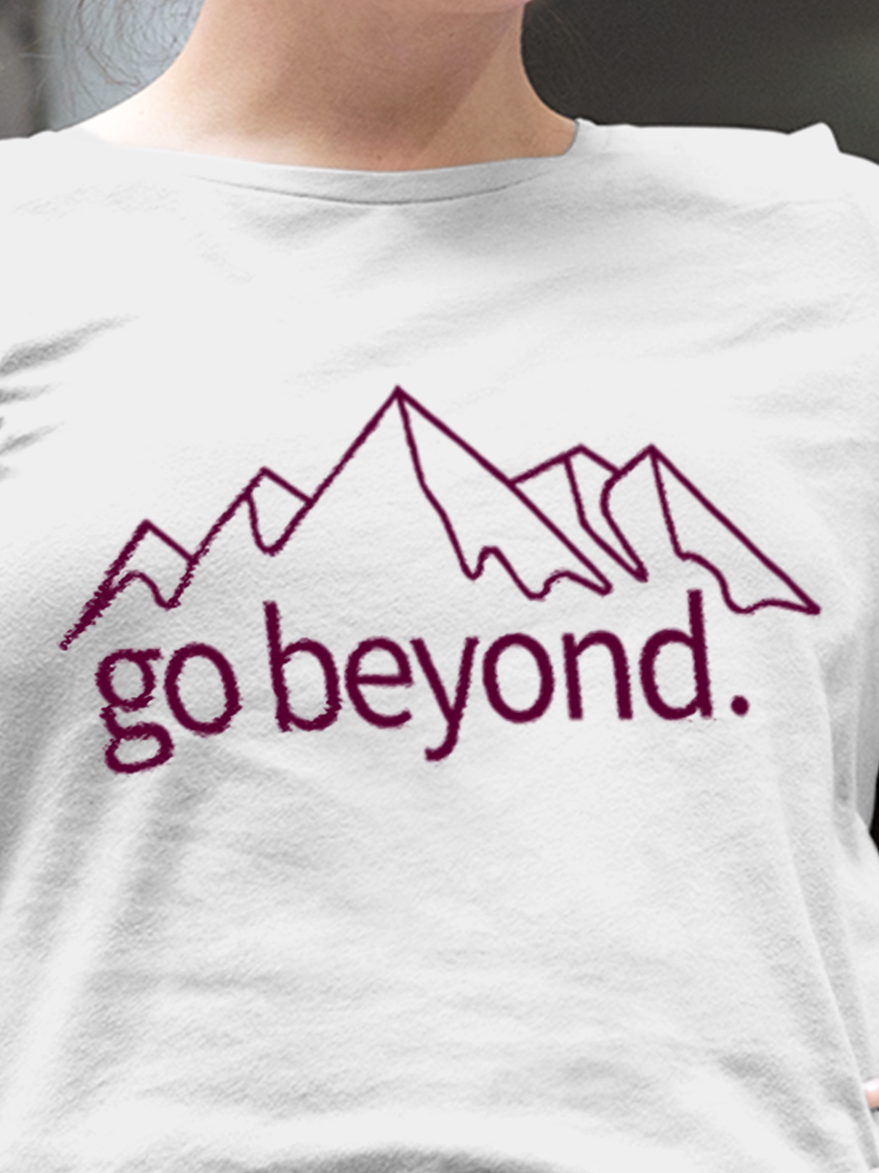 Close up of 'Go Beyond' design on Women's White Round Neck T-shirt, highlighting intricate details and vibrant print.