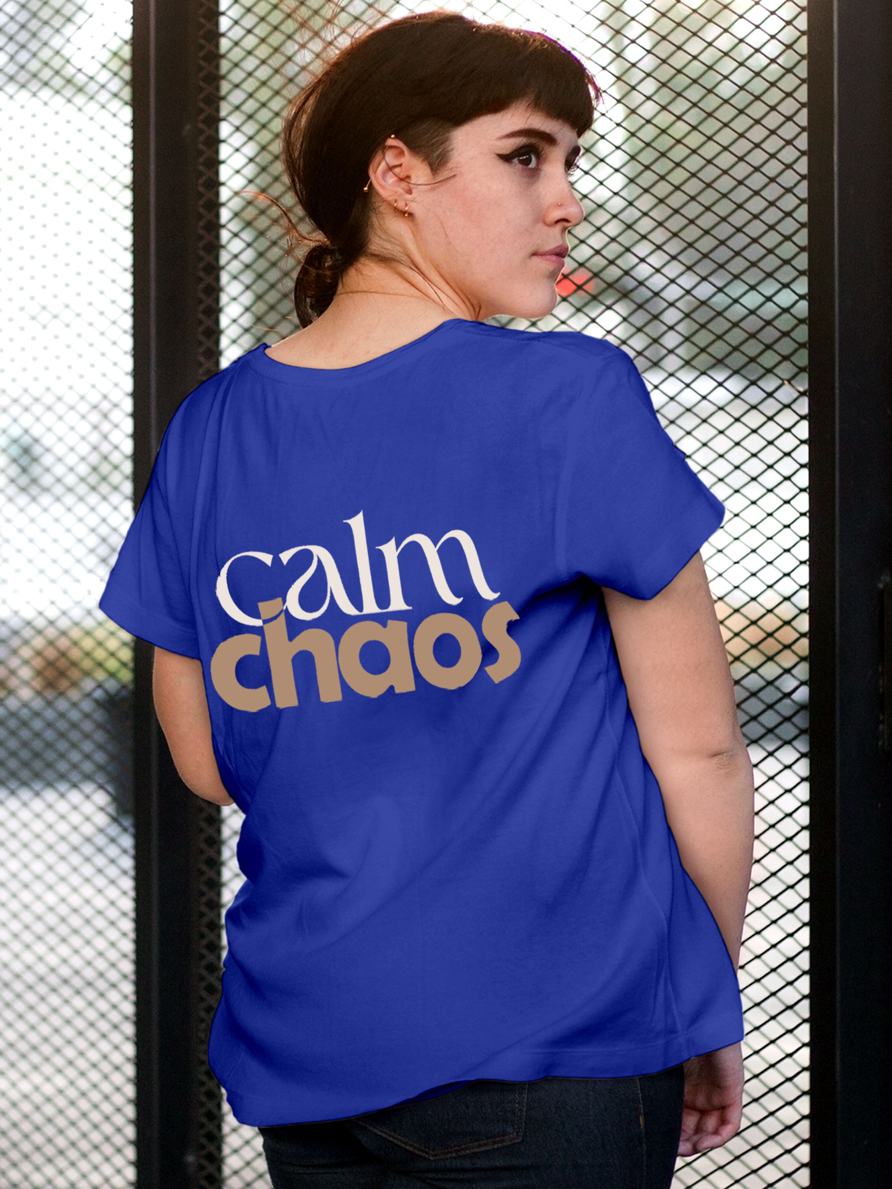 Model wearing Women's Blue Round Neck T-shirt with 'Calm Chaos' design, offering effortless style and premium comfort
