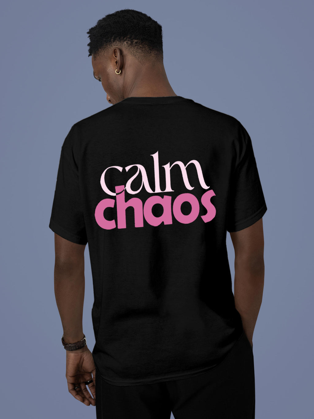 Model wearing Men's Black Round Neck T-shirt with 'Calm Chaos' design, offering effortless style and premium comfort