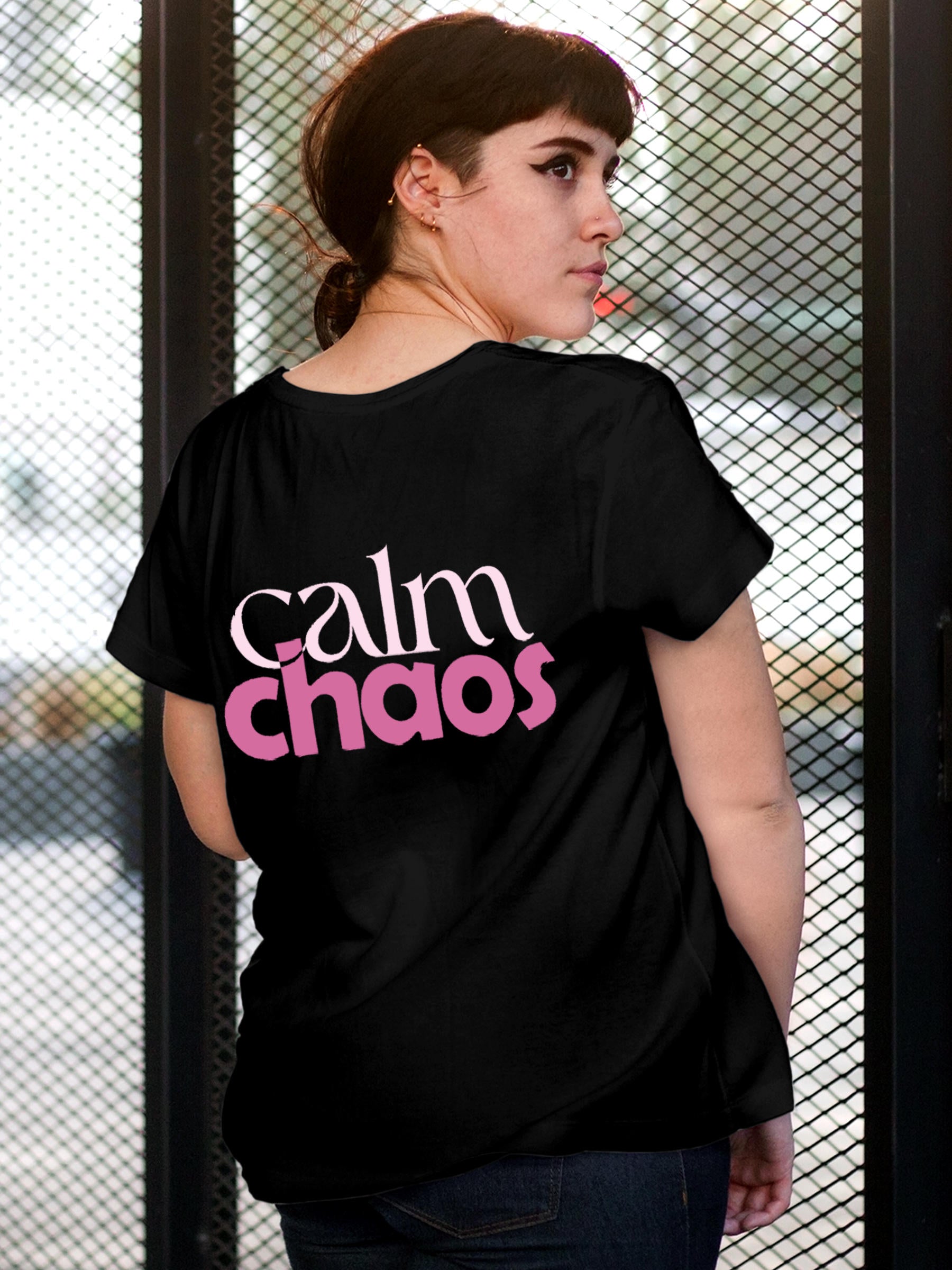 Model wearing Women's Black Round Neck T-shirt with 'Calm Chaos' design, offering effortless style and premium comfort