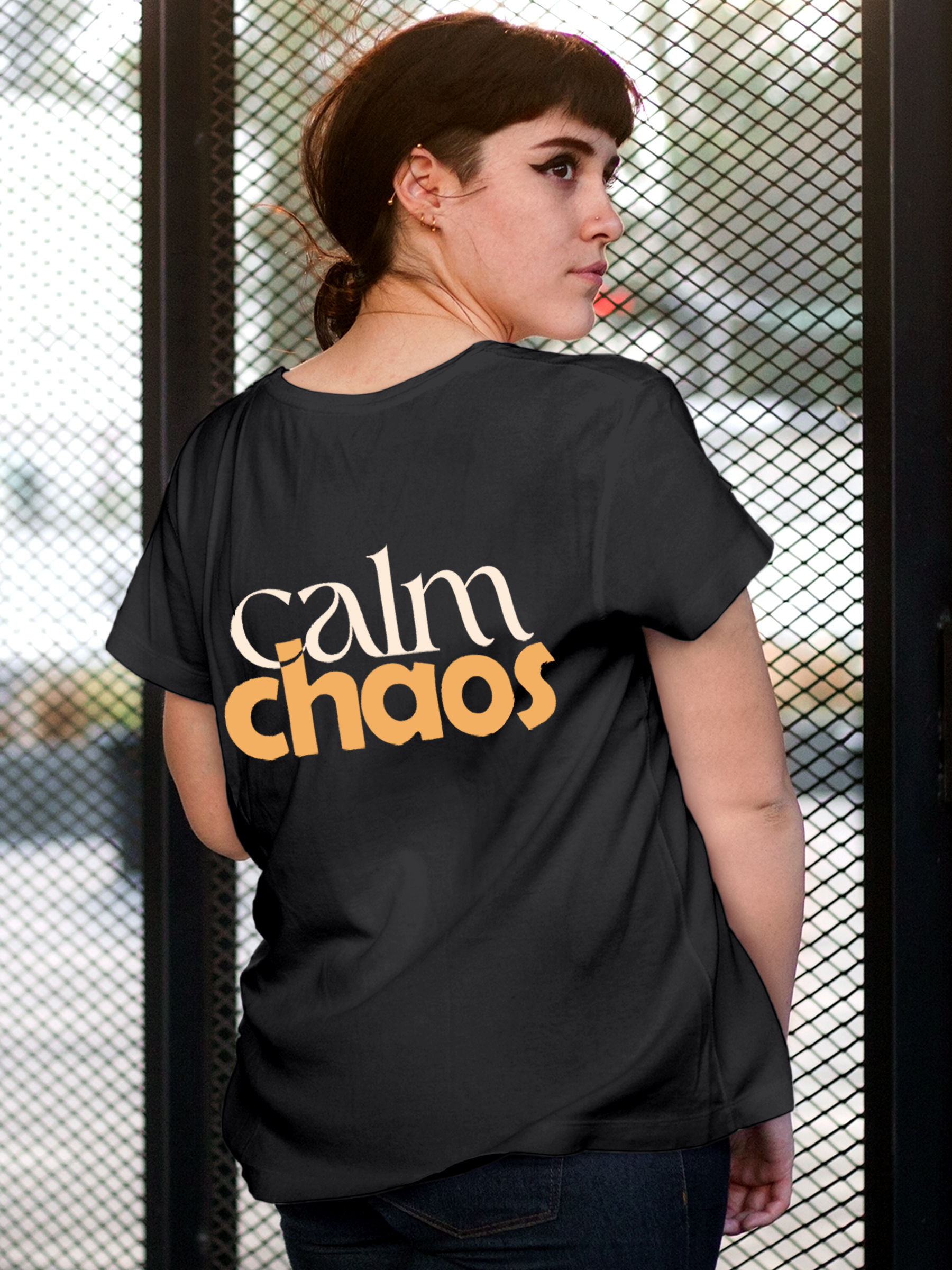 Model wearing Women's Charcoal Grey Round Neck T-shirt with 'Calm Chaos' design, offering effortless style and premium comfort