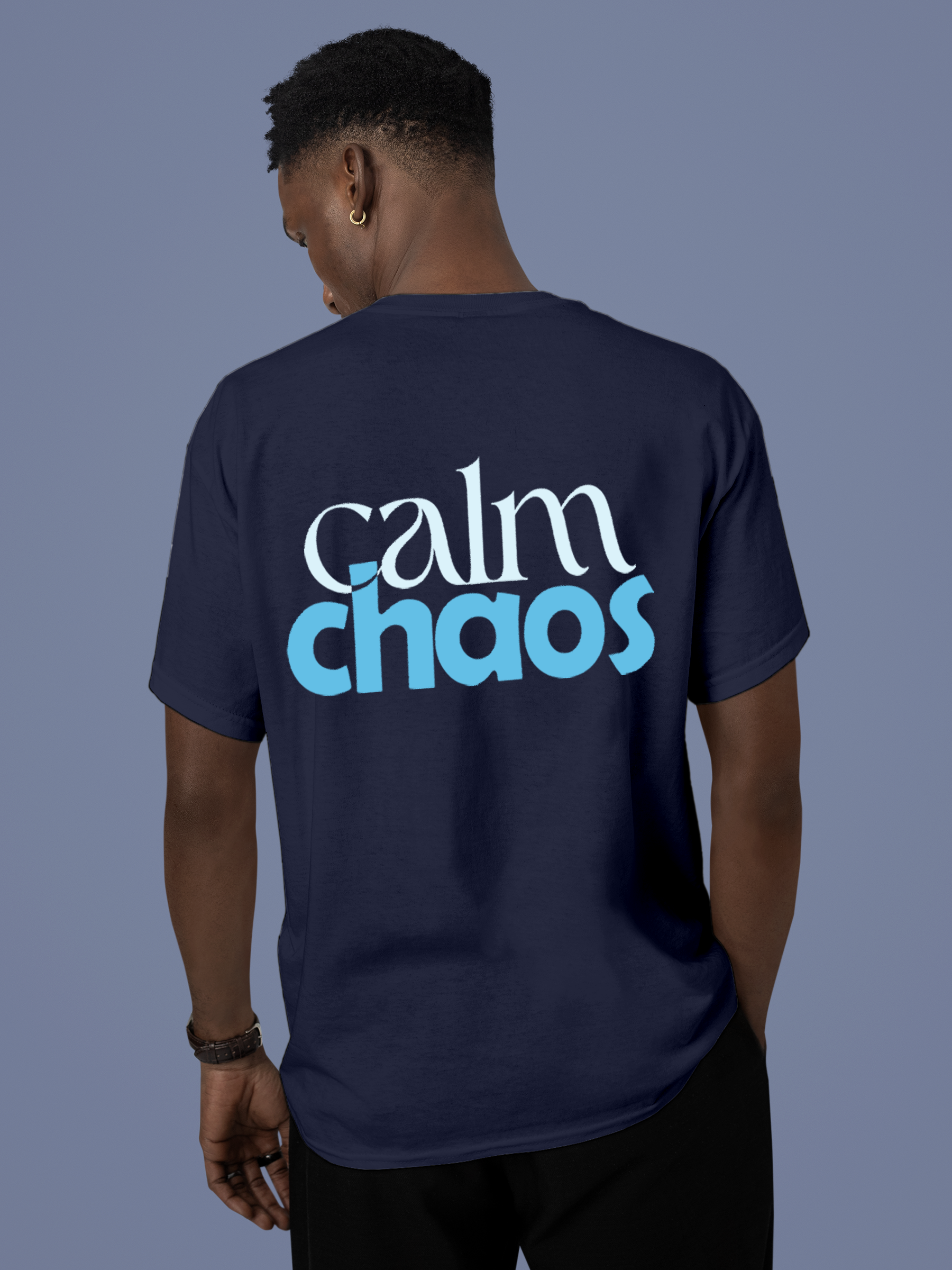 Model wearing Men's Navy Blue Round Neck T-shirt with 'Calm Chaos' design, offering effortless style and premium comfort