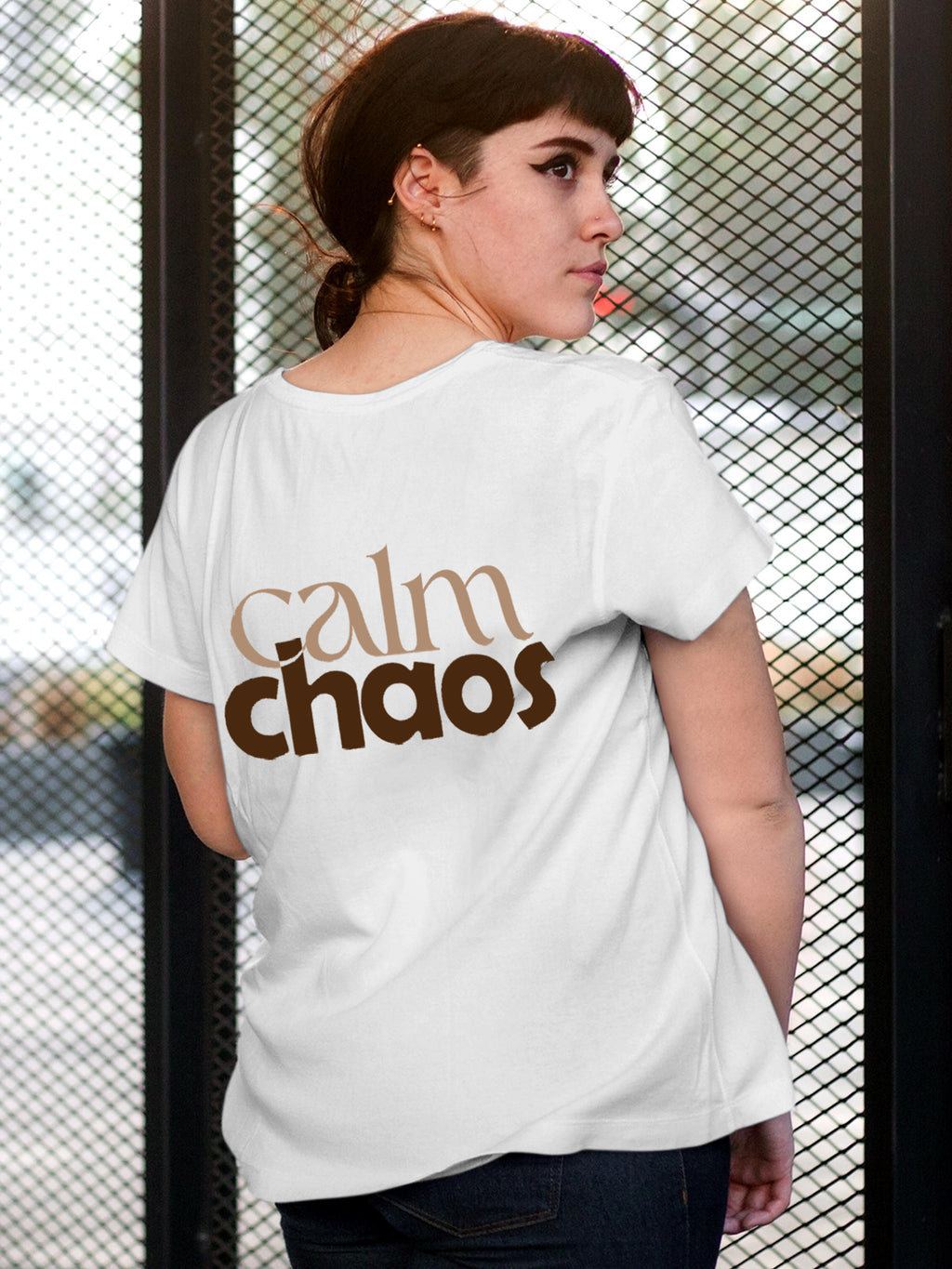 Model wearing Women's White Round Neck T-shirt with 'Calm Chaos' design, offering effortless style and premium comfort