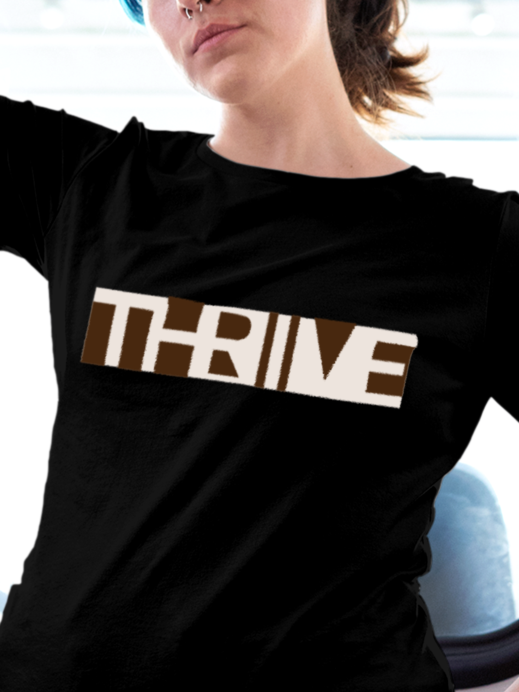 Close up of 'Thrive' design on Women's Black Round Neck T-shirt, highlighting intricate details and vibrant print.