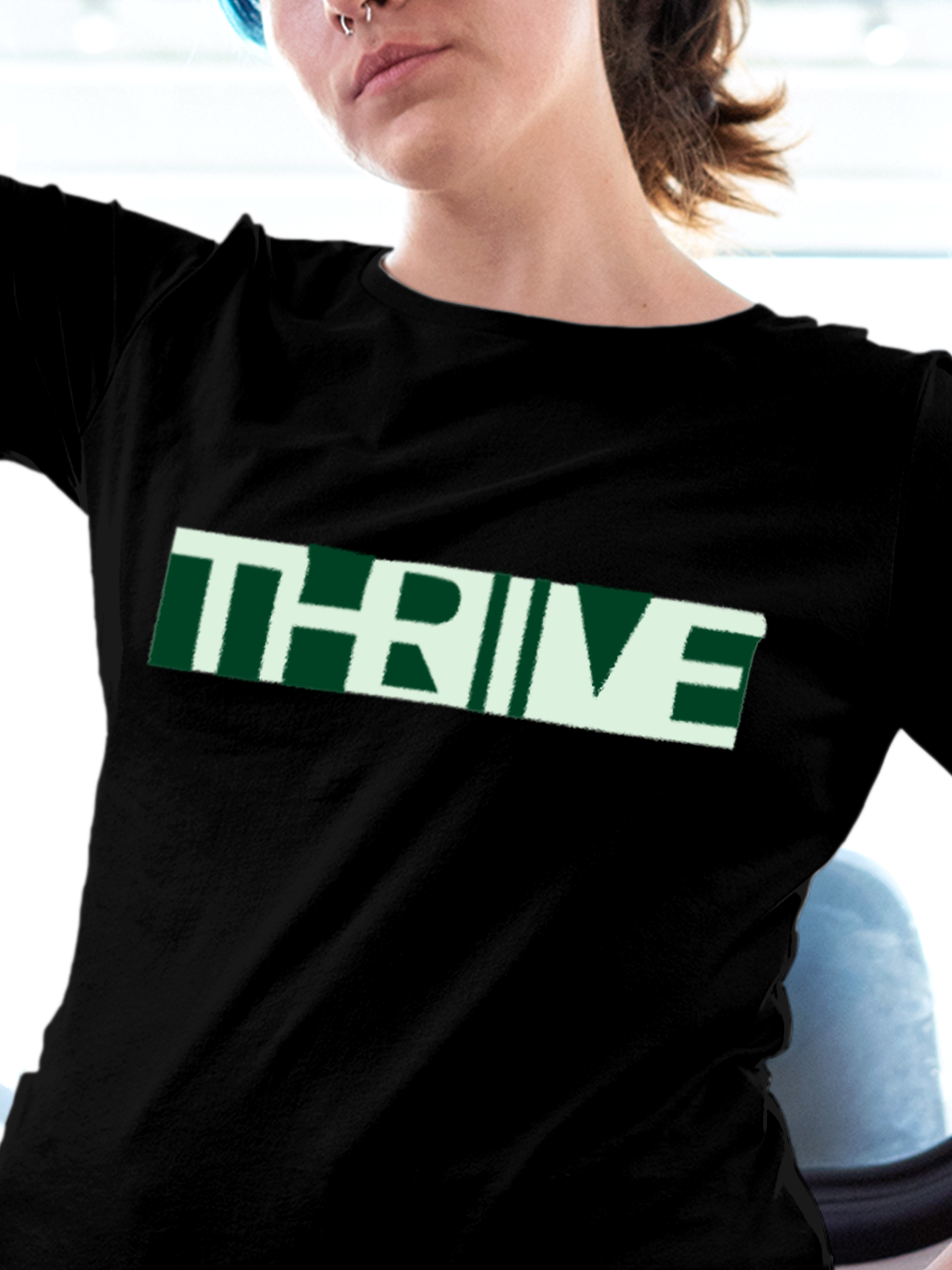Close up of 'Thrive' design on Women's Black Round Neck T-shirt, highlighting intricate details and vibrant print.