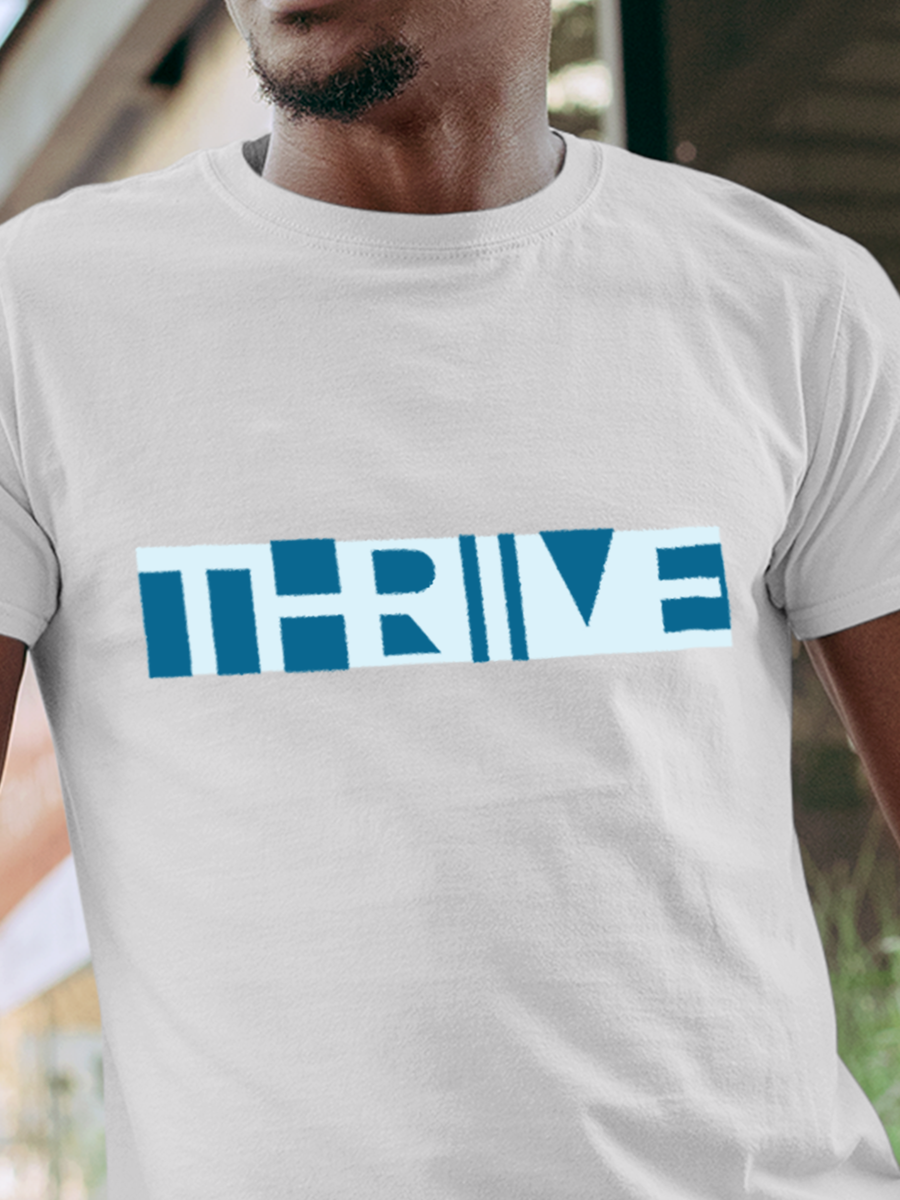 Close up of 'Thrive' design on Men's White Round Neck T-shirt, highlighting intricate details and vibrant print.