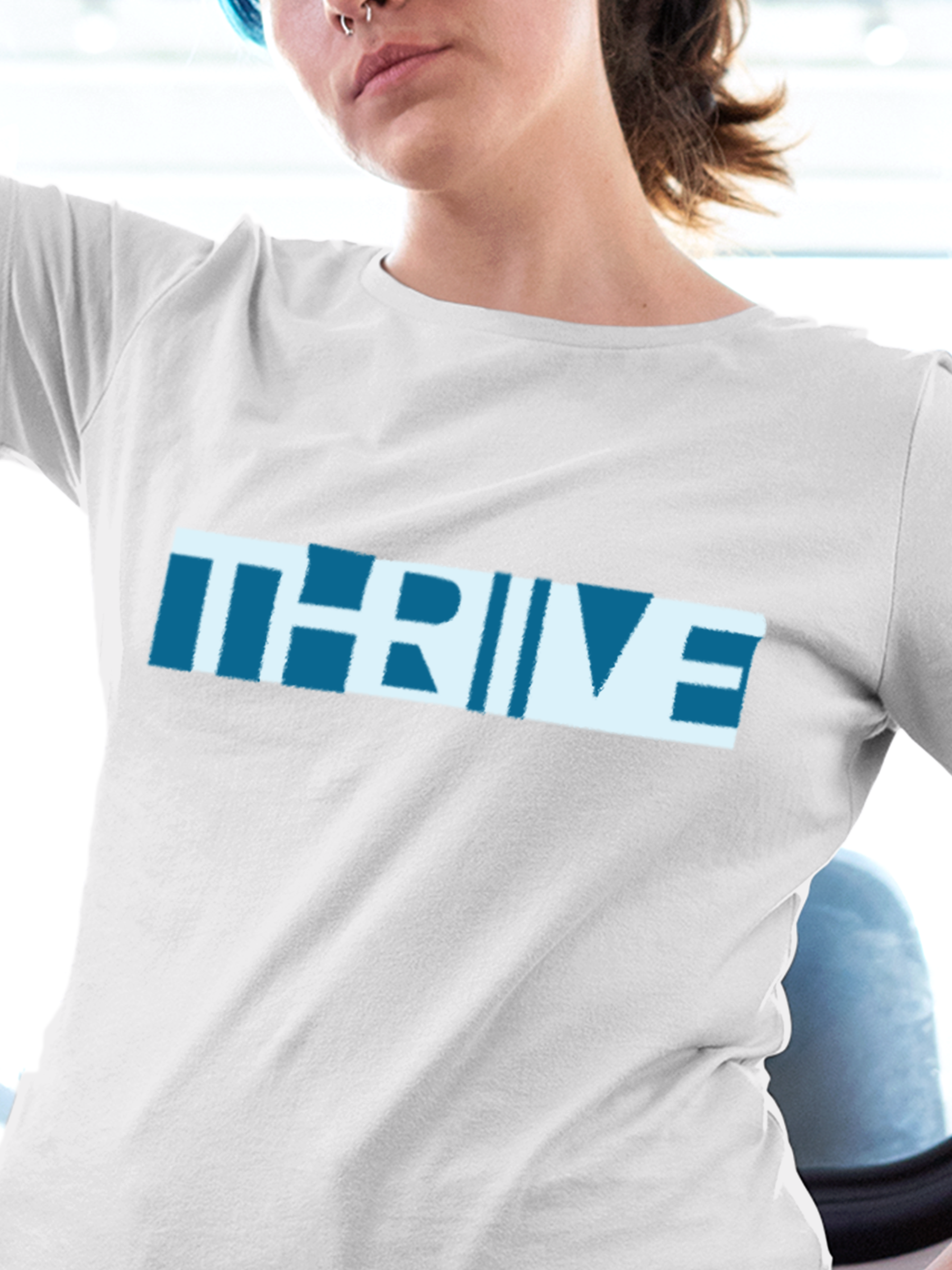 Close up of 'Thrive' design on Women's White Round Neck T-shirt, highlighting intricate details and vibrant print.